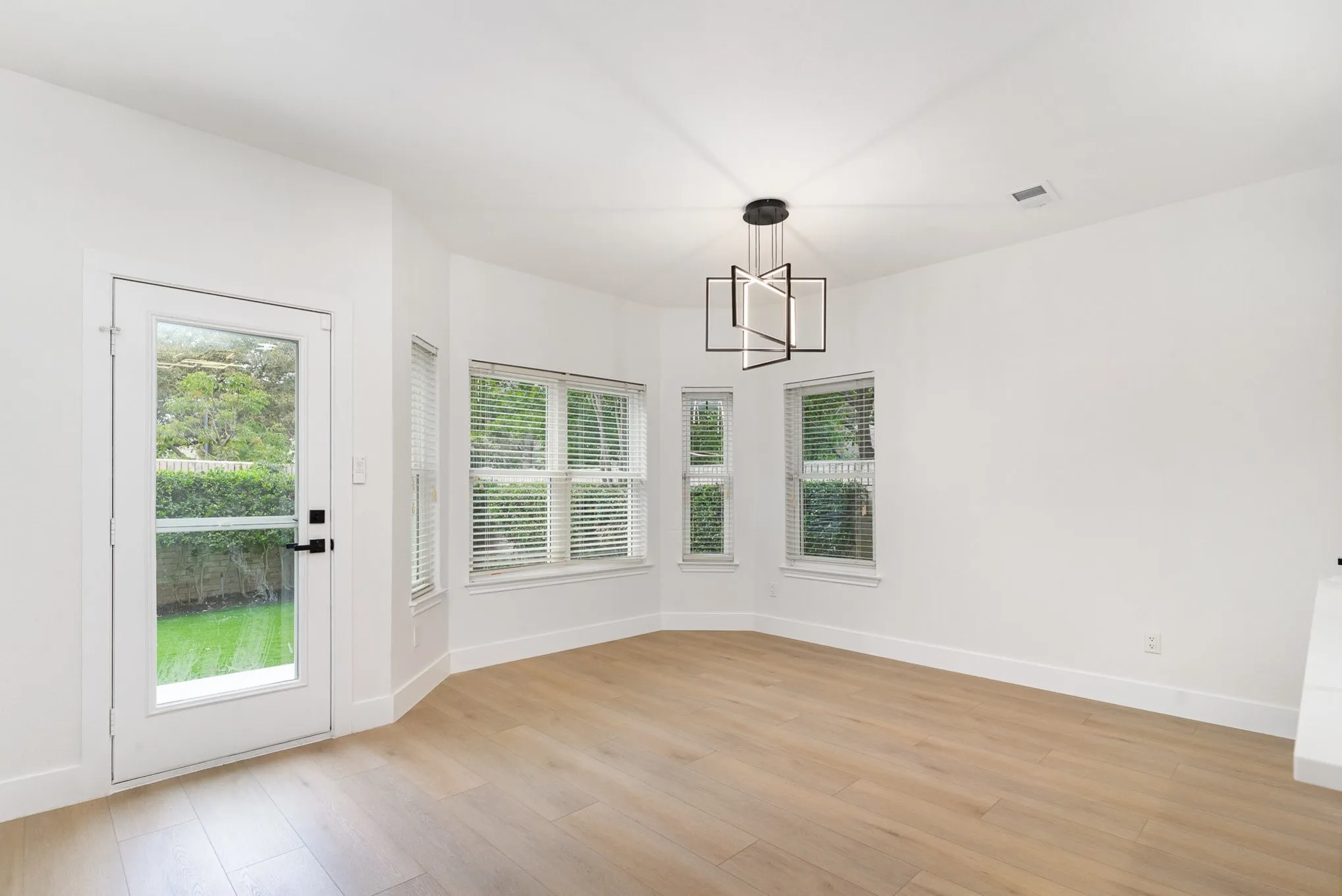 Unfurnished dining area featuring light wood-type flooring and a notable chandelier