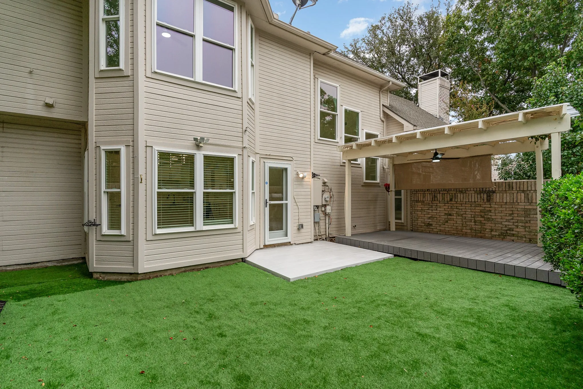 Back of property with a lawn and a patio area