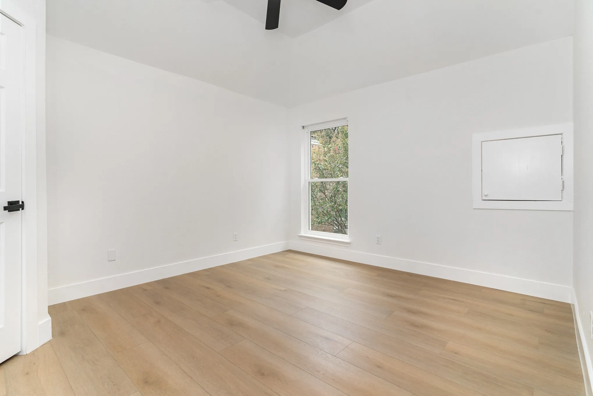 Spare room with light wood-type flooring and ceiling fan