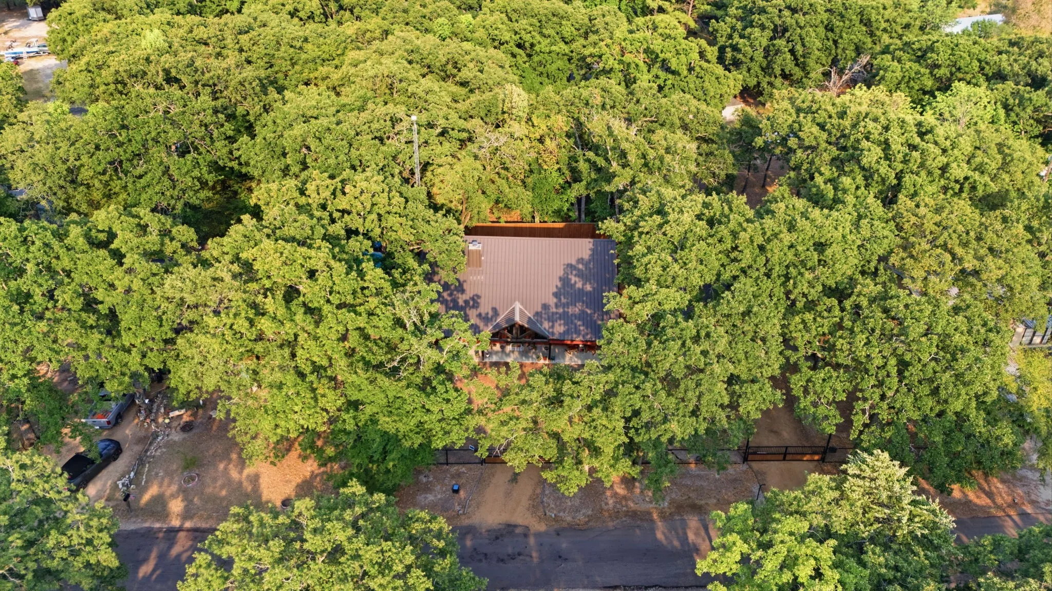 Metal roof residence nestled among mature trees