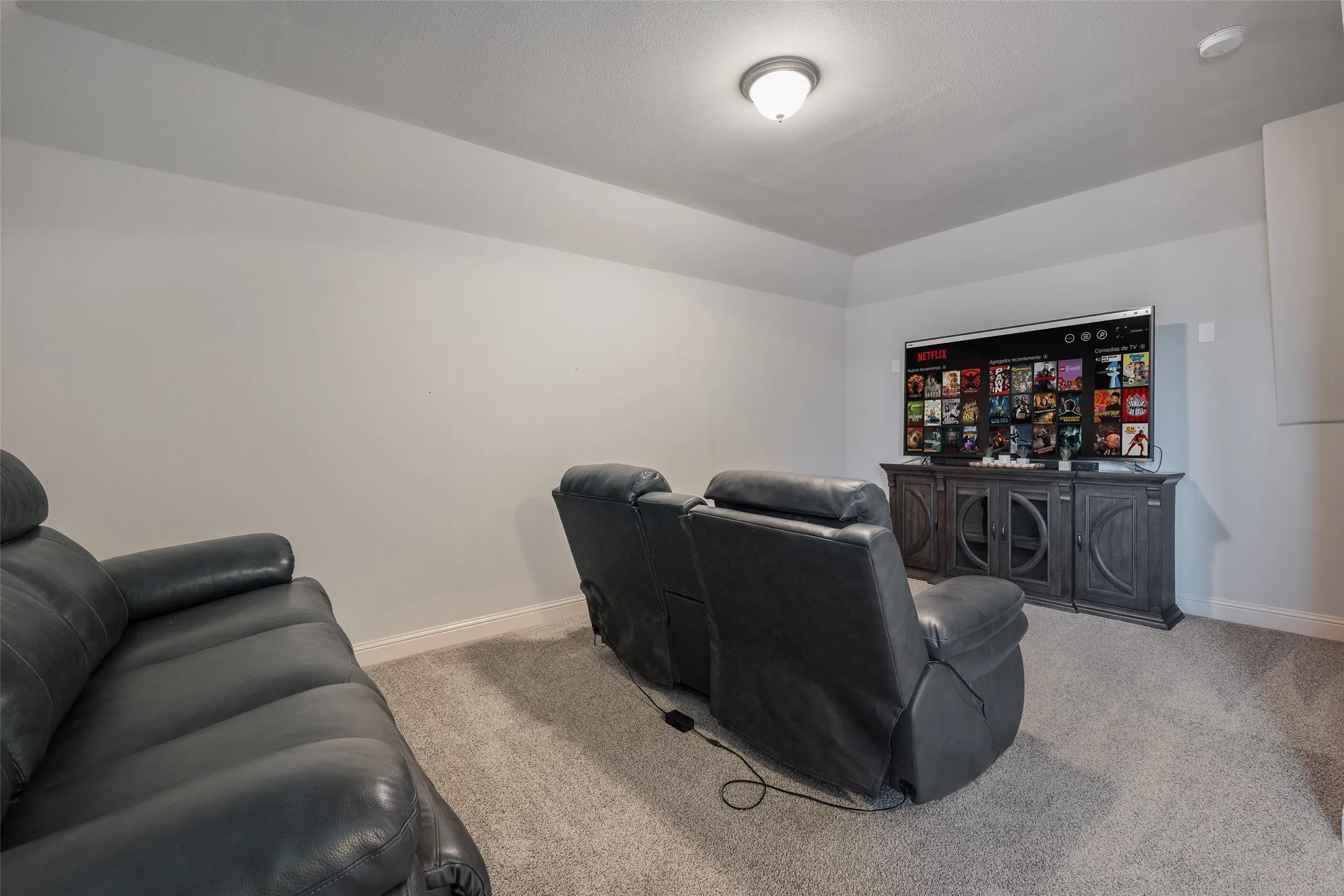 Carpeted flooring, neutral wall tones, and recessed ceiling lighting