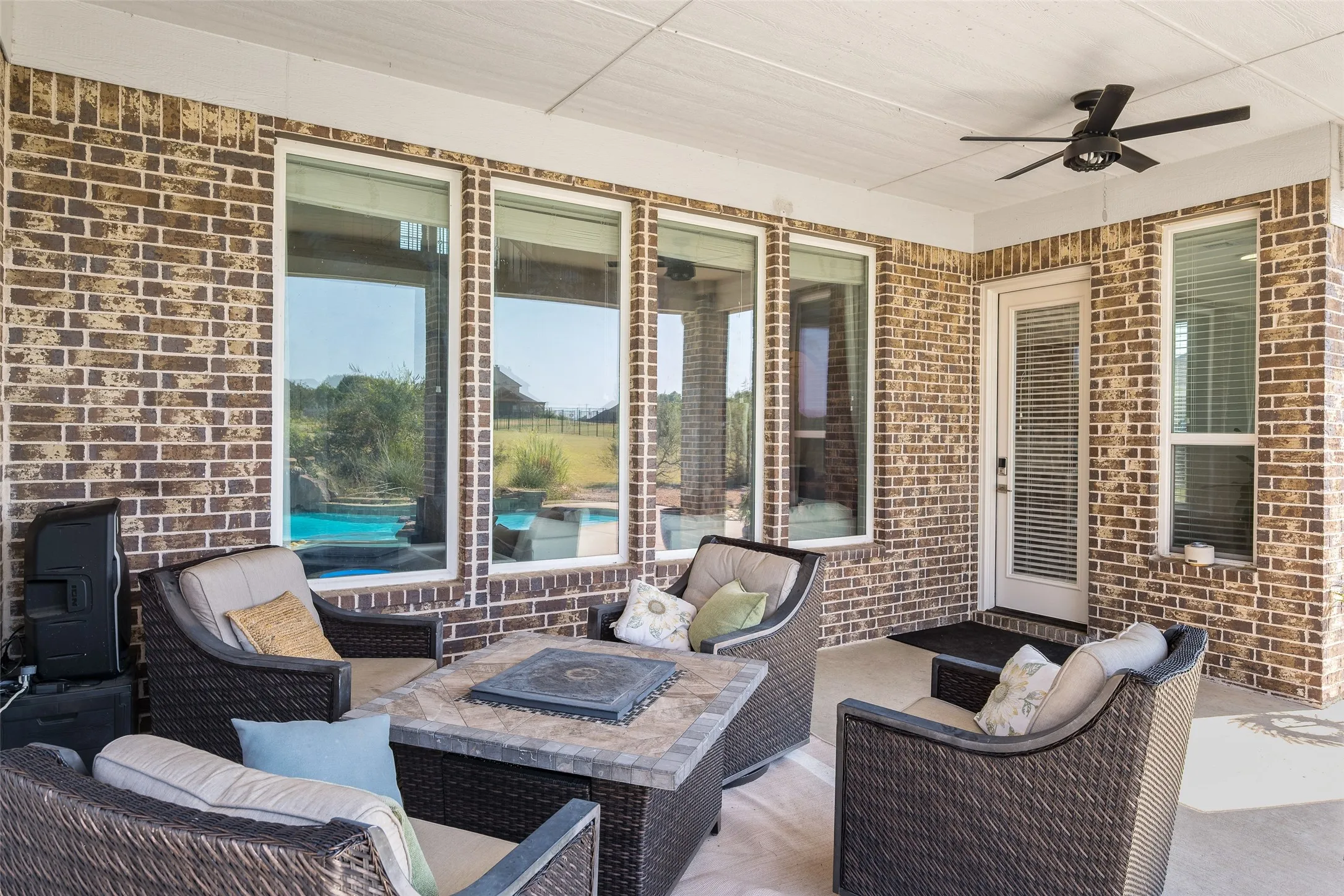 Covered patio featuring a brick exterior, recessed lighting, and a ceiling fan