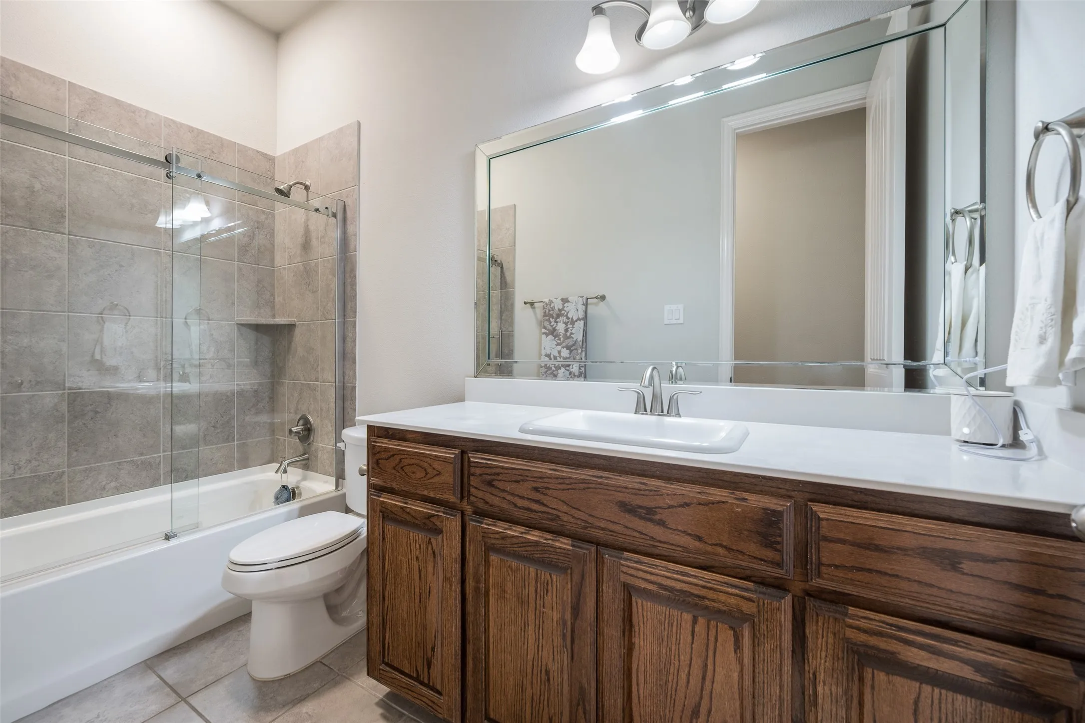 Hardwood vanity with white countertop and rectangular sink