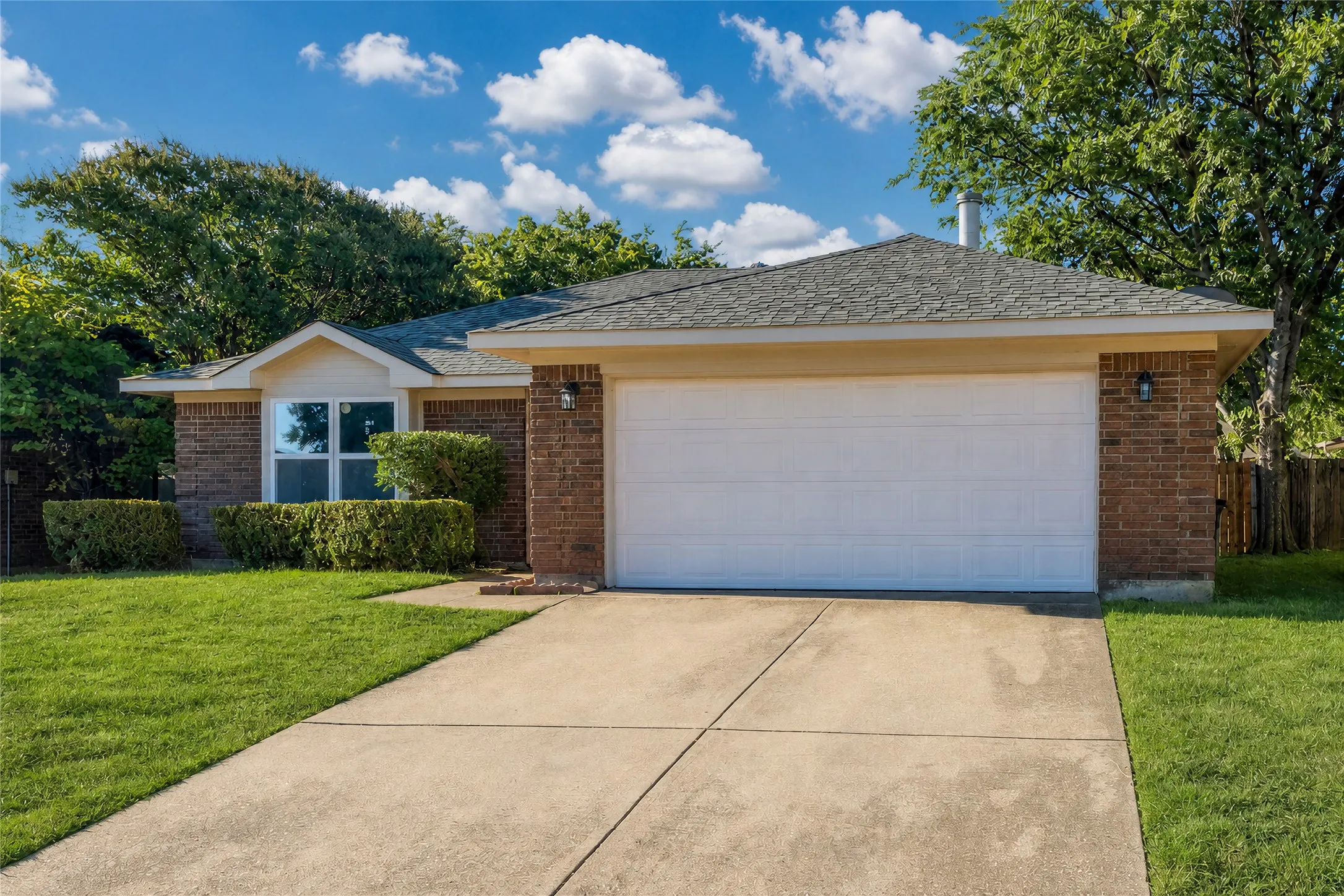 Brick exterior with a gabled roof and a two-car garage