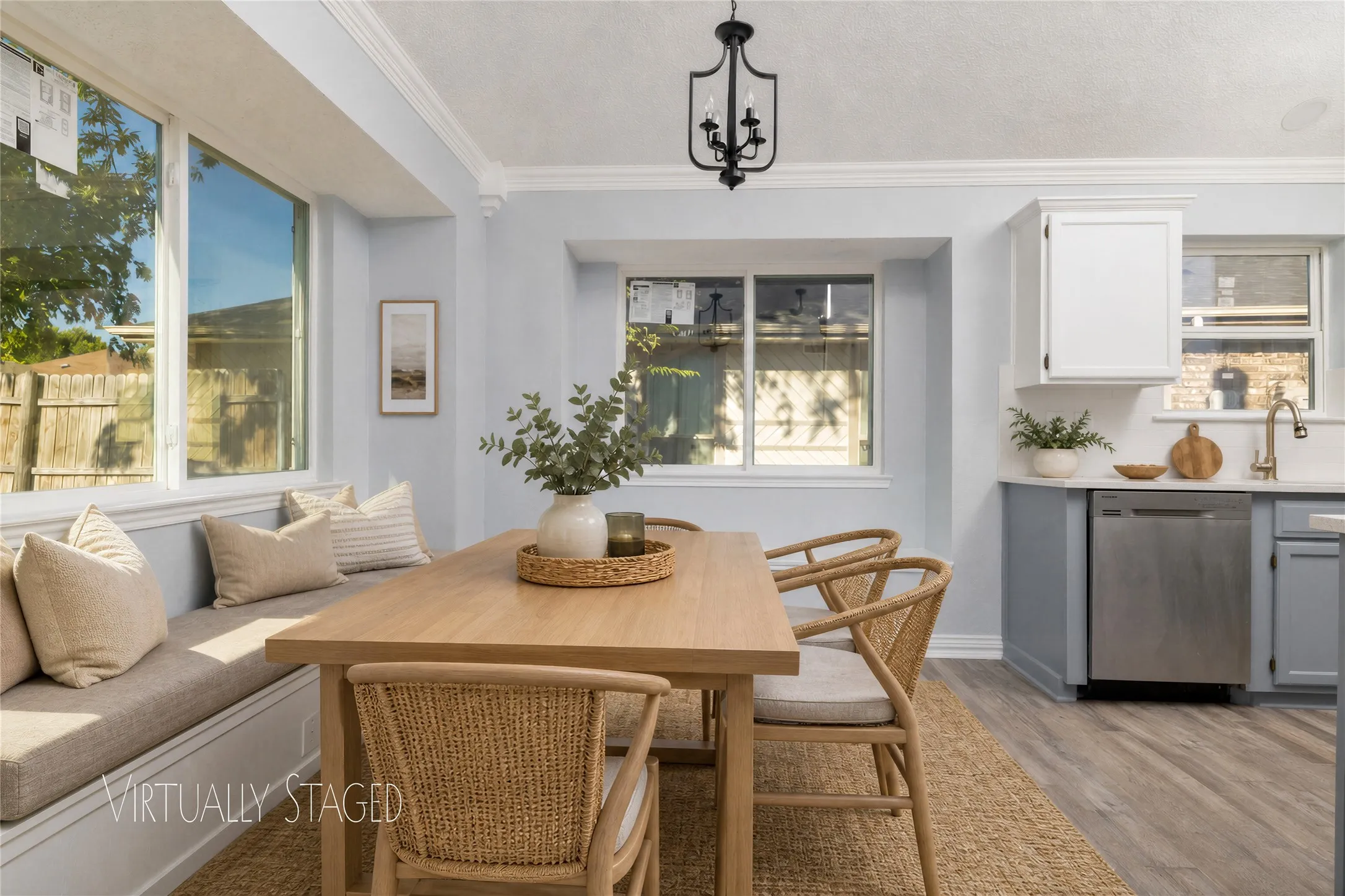 Built-in bench seating, wood-finish flooring, recessed lighting, and a stainless steel appliance