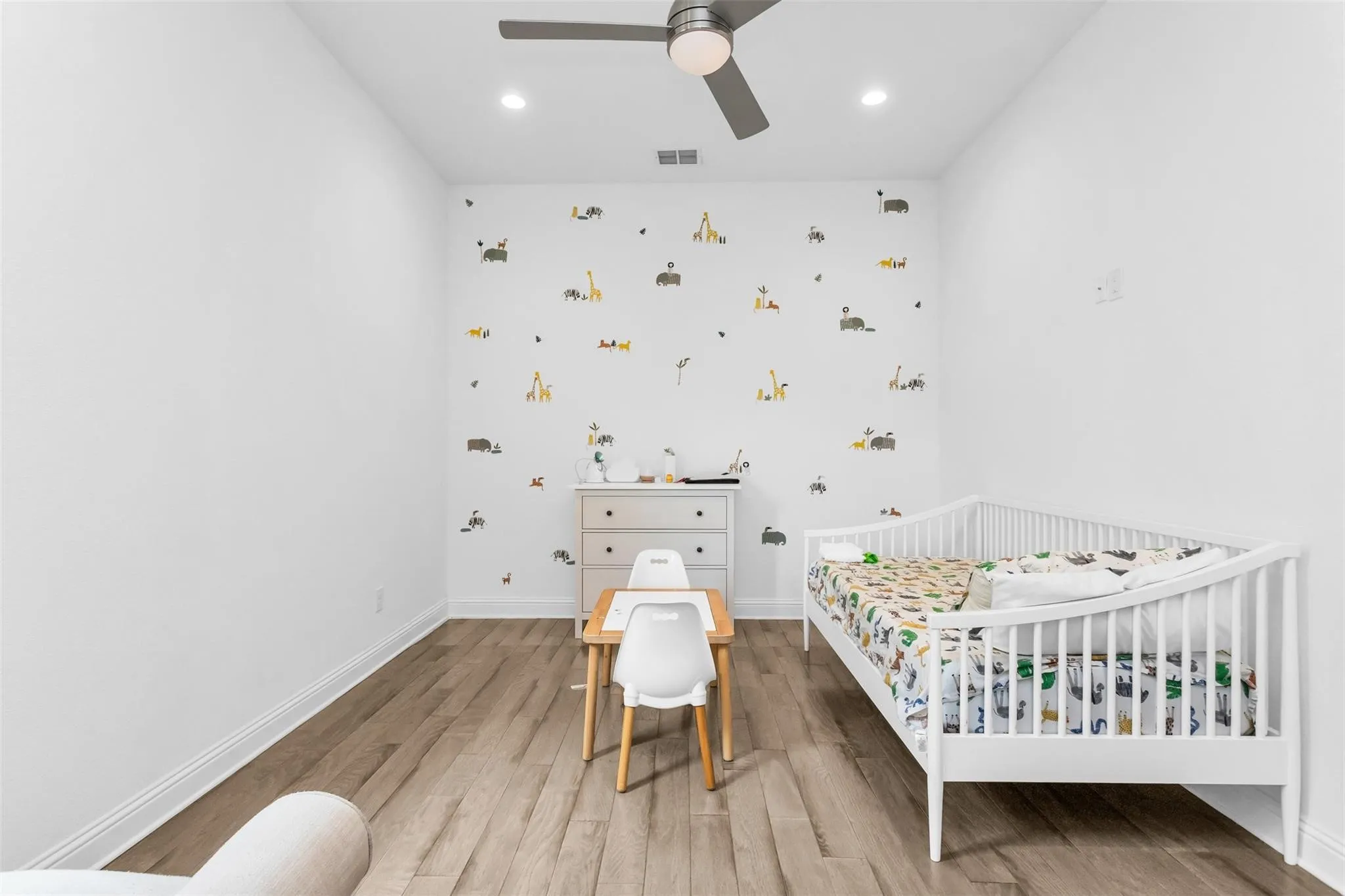 Wood-finish flooring, recessed lighting, and a ceiling fan