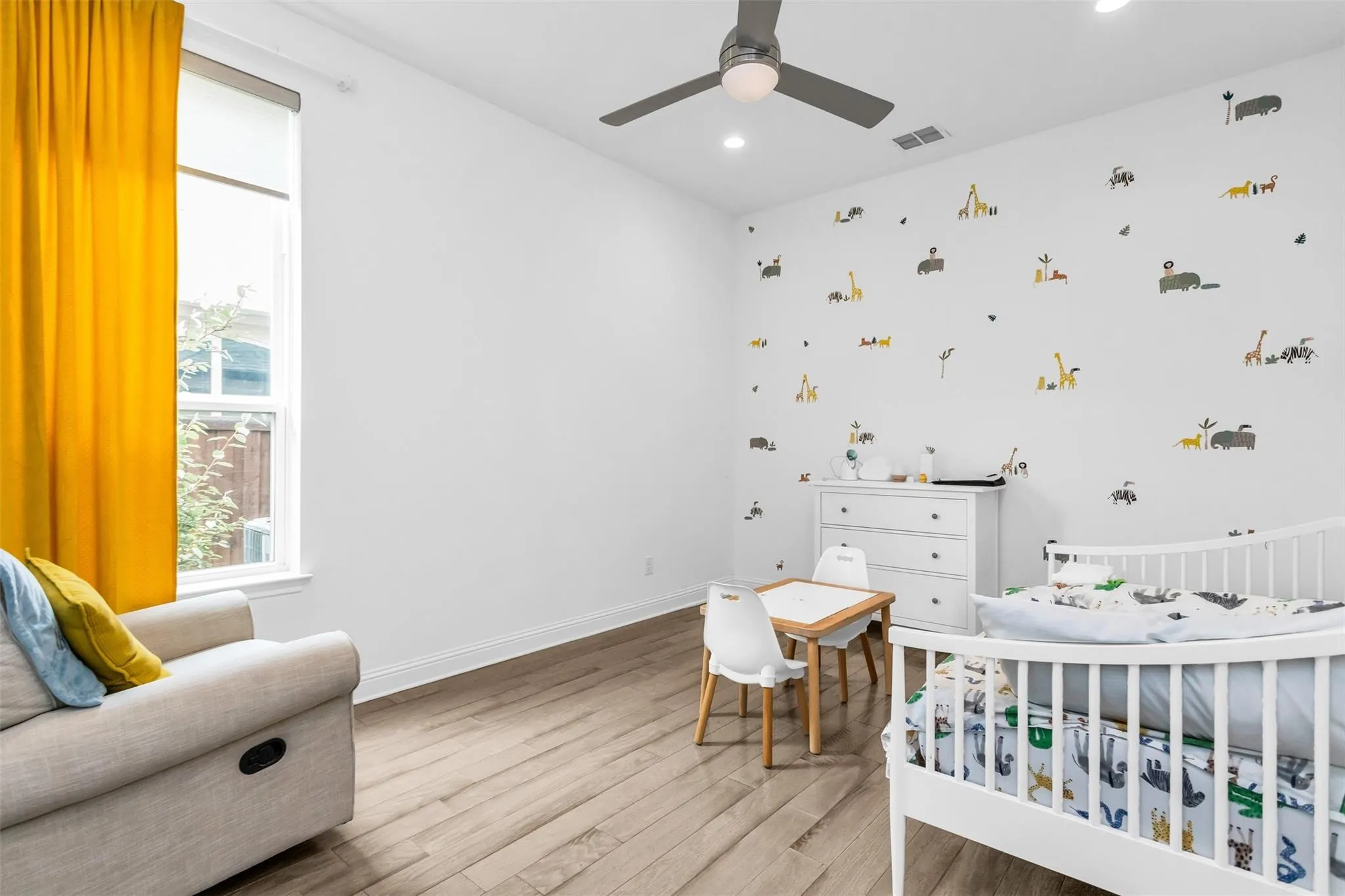 Bright interior with wood-finish flooring, recessed lighting, and a ceiling fan