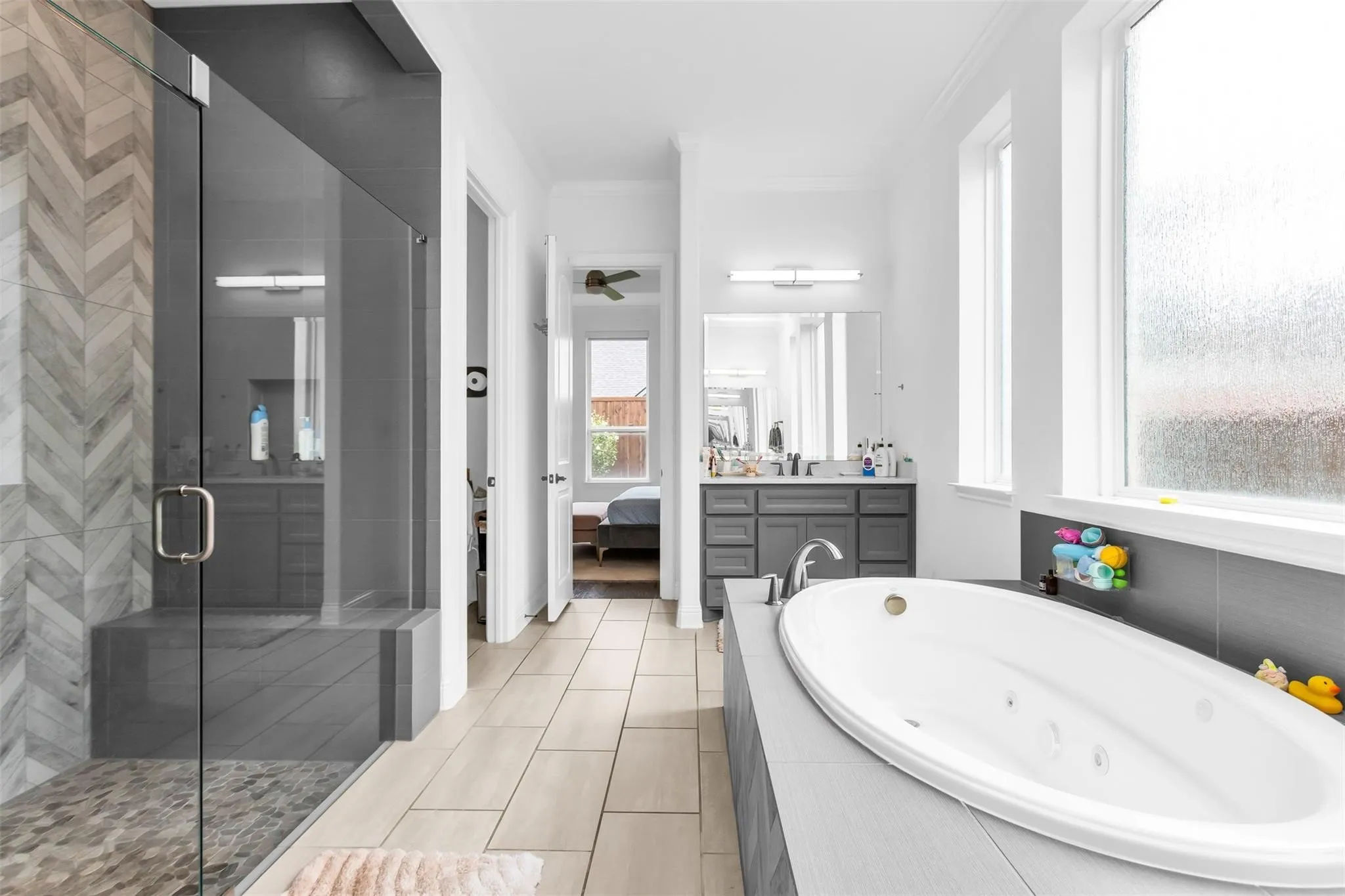 Walk-in shower with chevron-patterned tile and integrated bench