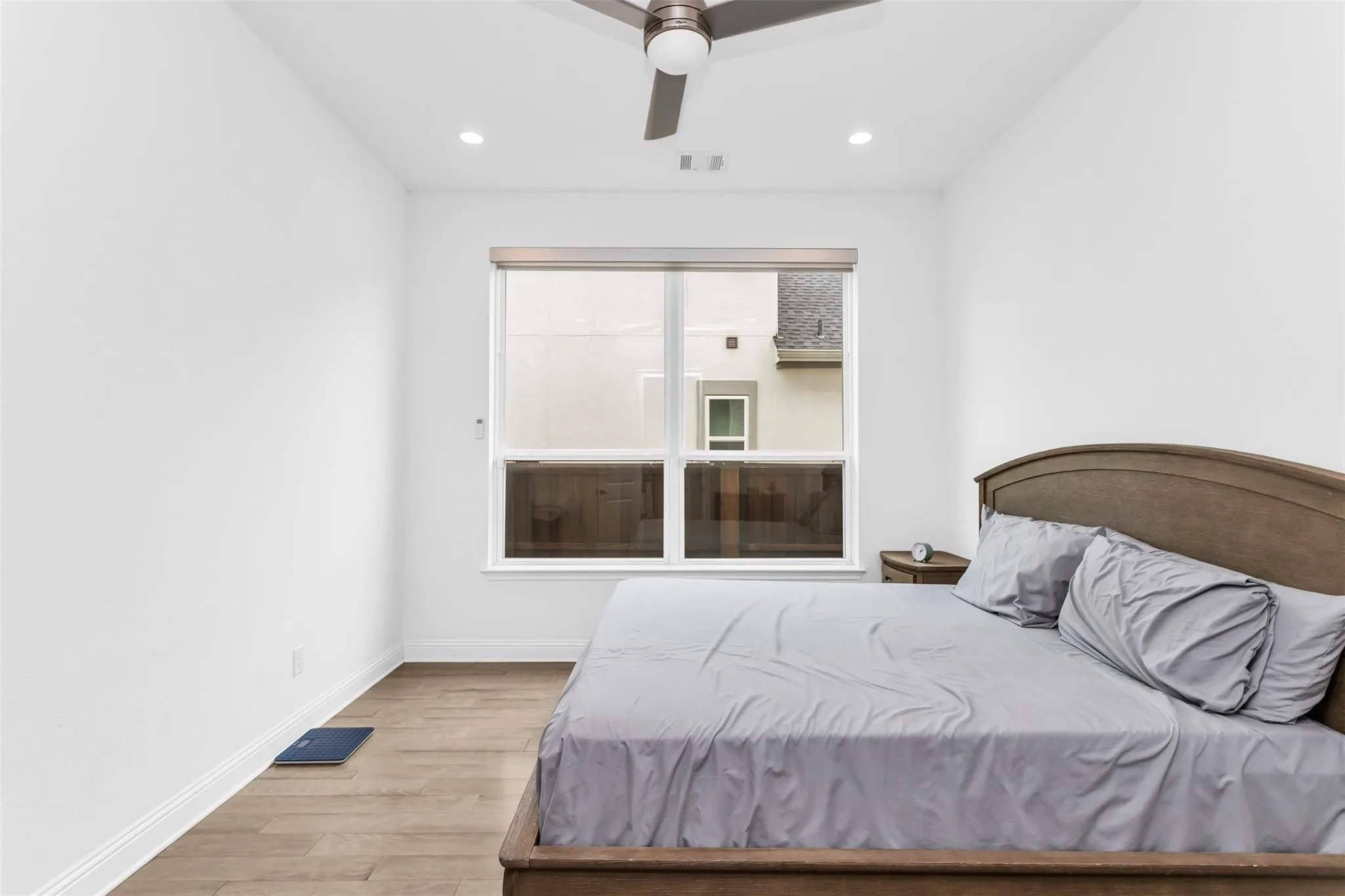 Recessed lighting, wood-finish flooring, and a ceiling fan with light fixture