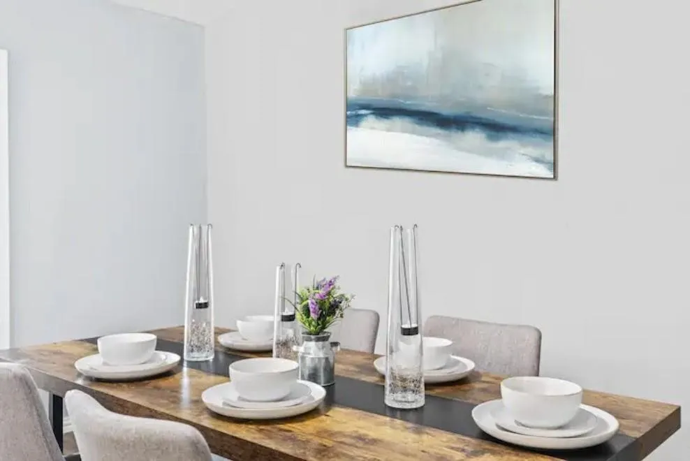 Wood-finish dining table with a dark contrasting inlay