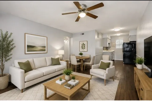Open-concept living area with dark wood-finish flooring, ceiling fan, and recessed lighting