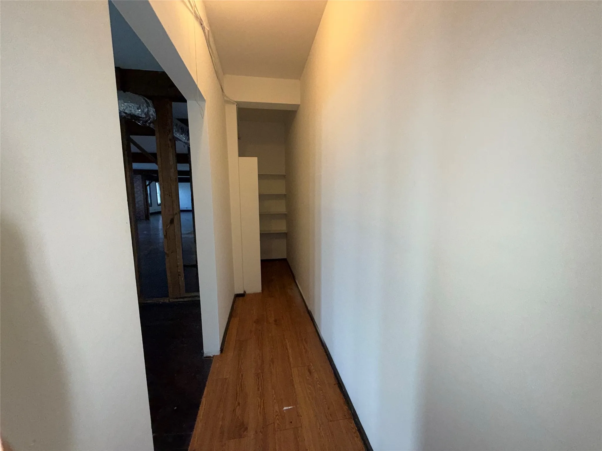Wood-finish flooring with white painted walls