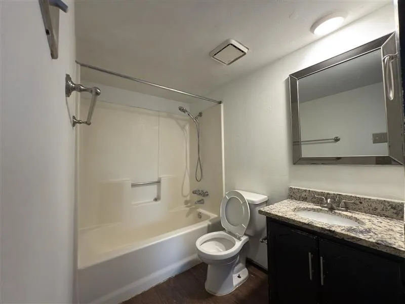 Bathroom featuring a vanity with a light-colored countertop, an integrated sink, and a dark-finish cabinet base