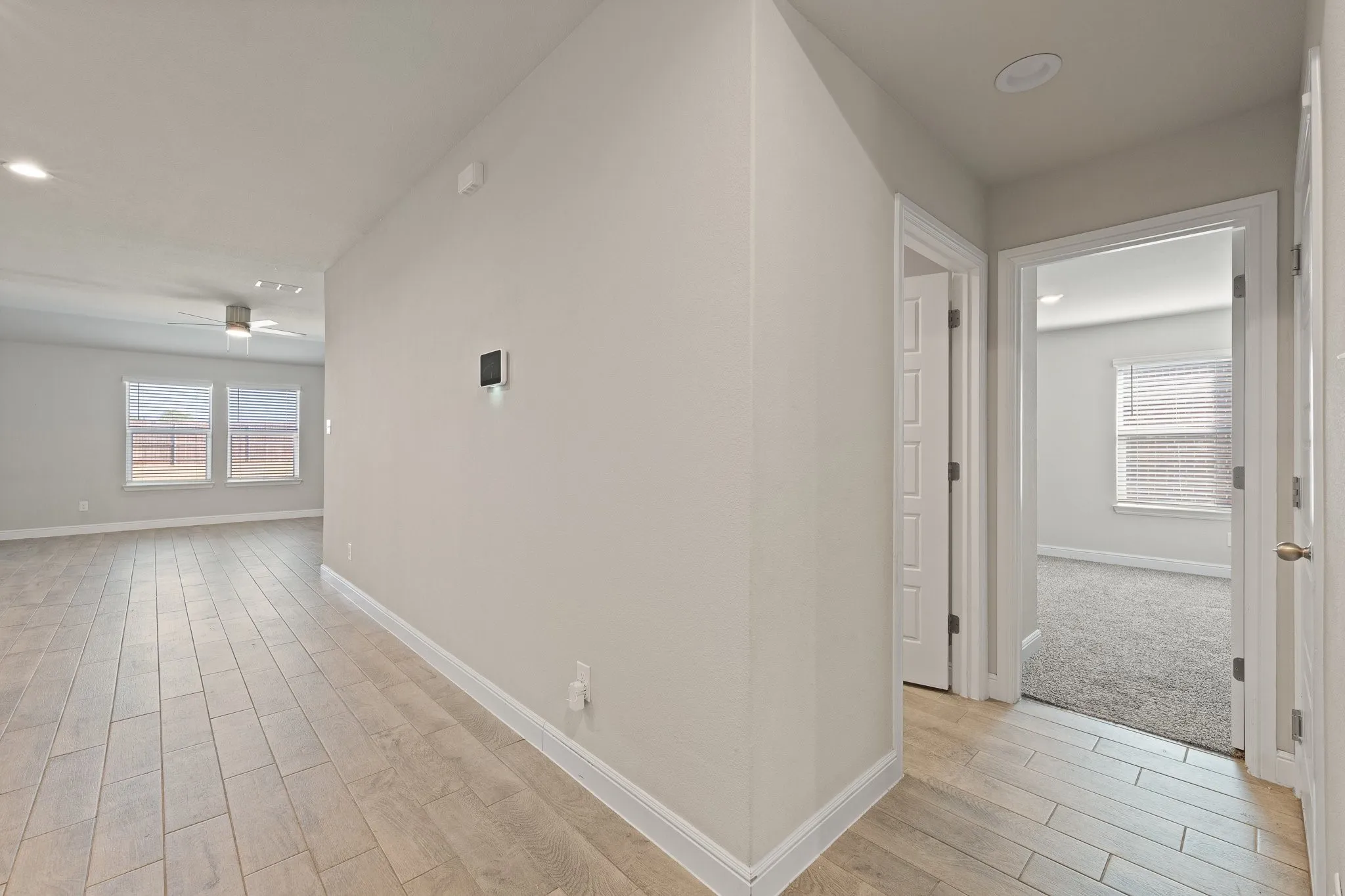 Wood-finish tile flooring throughout, recessed lighting, and a contemporary ceiling fan
