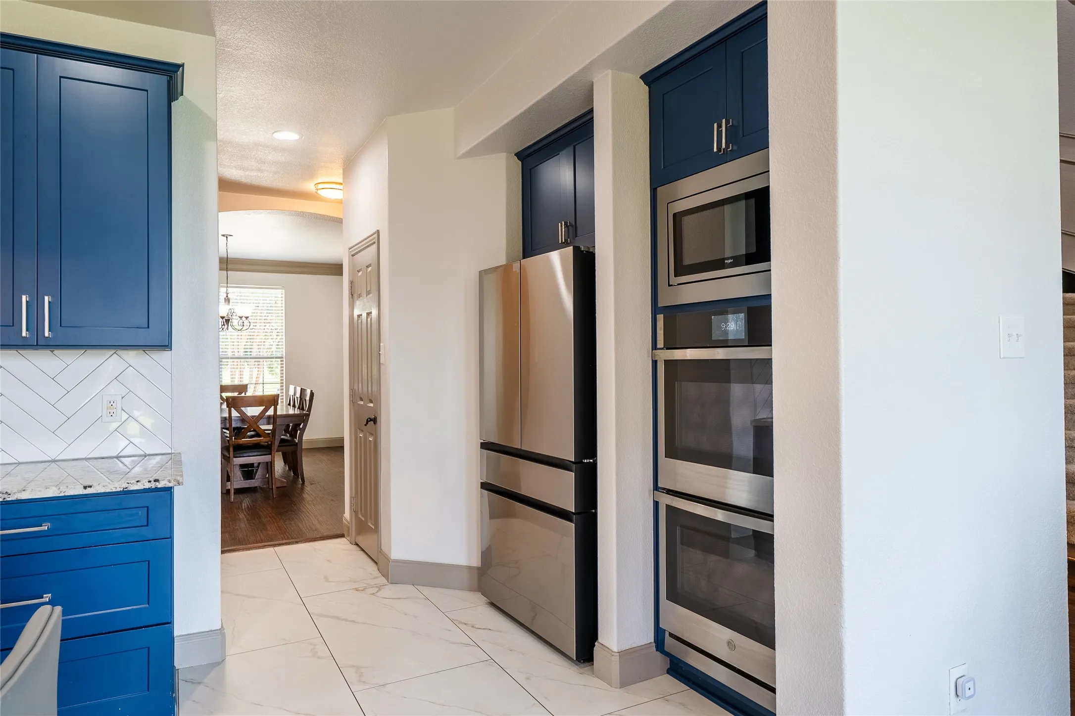 Stainless steel built-in double ovens, microwave, and refrigerator