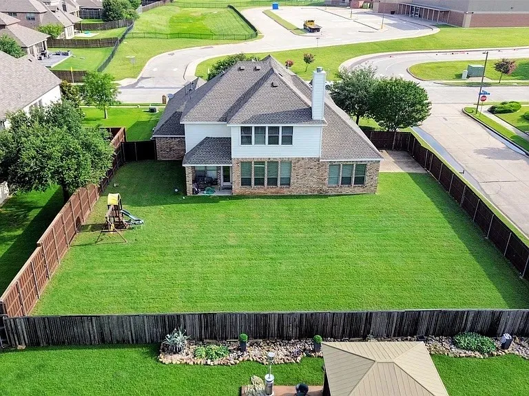 Two-story residence featuring brick and siding exterior, a gabled roof, and multiple rear windows