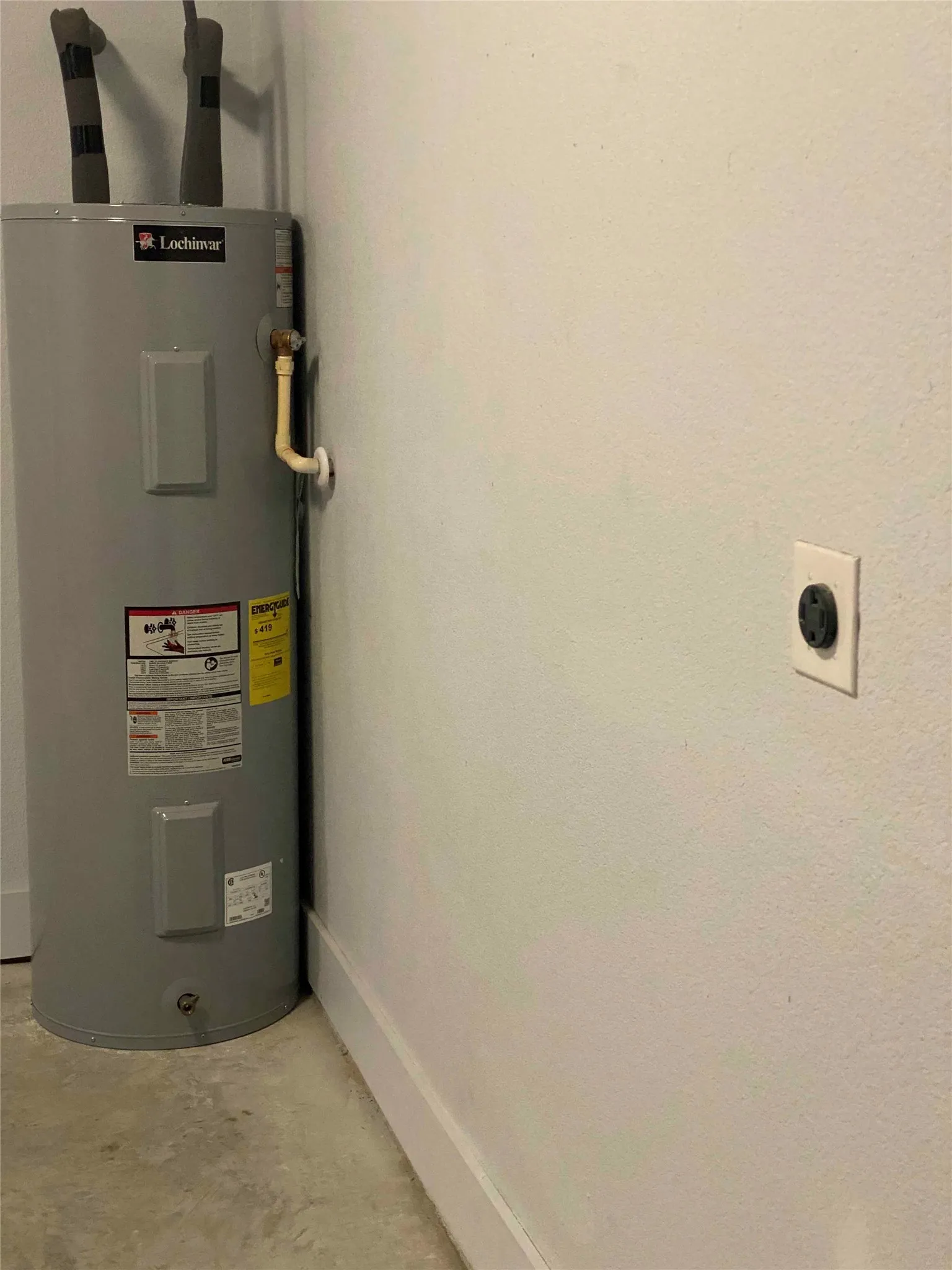 Utility room with electric water heater and wall EV charger outlet