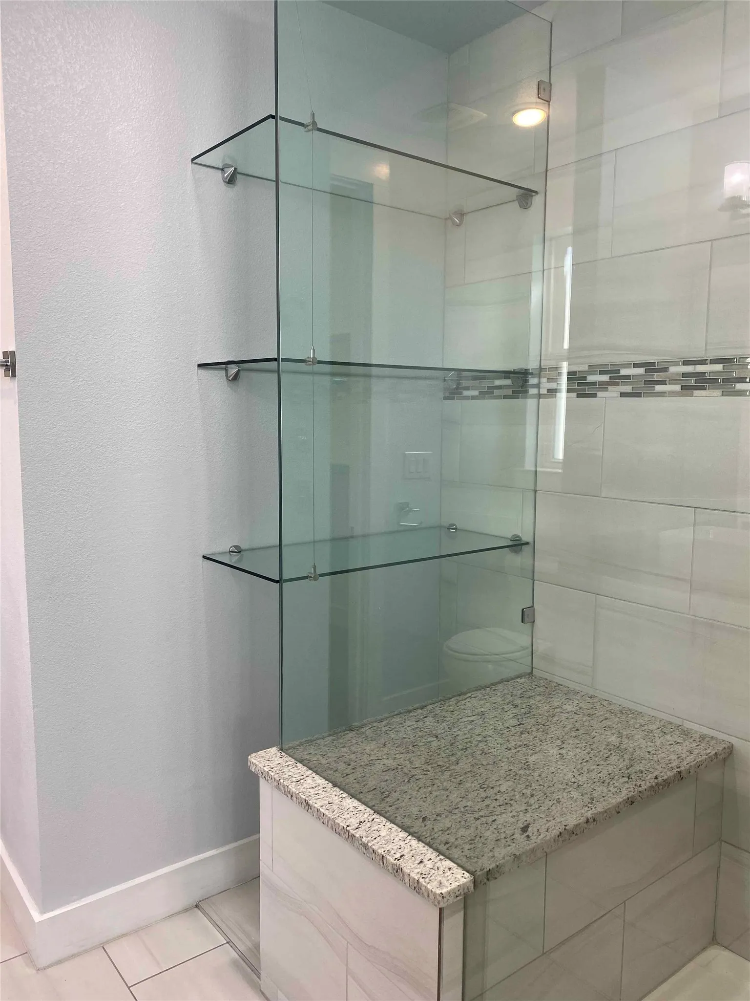 Full bathroom with a stall shower and light tile patterned floors