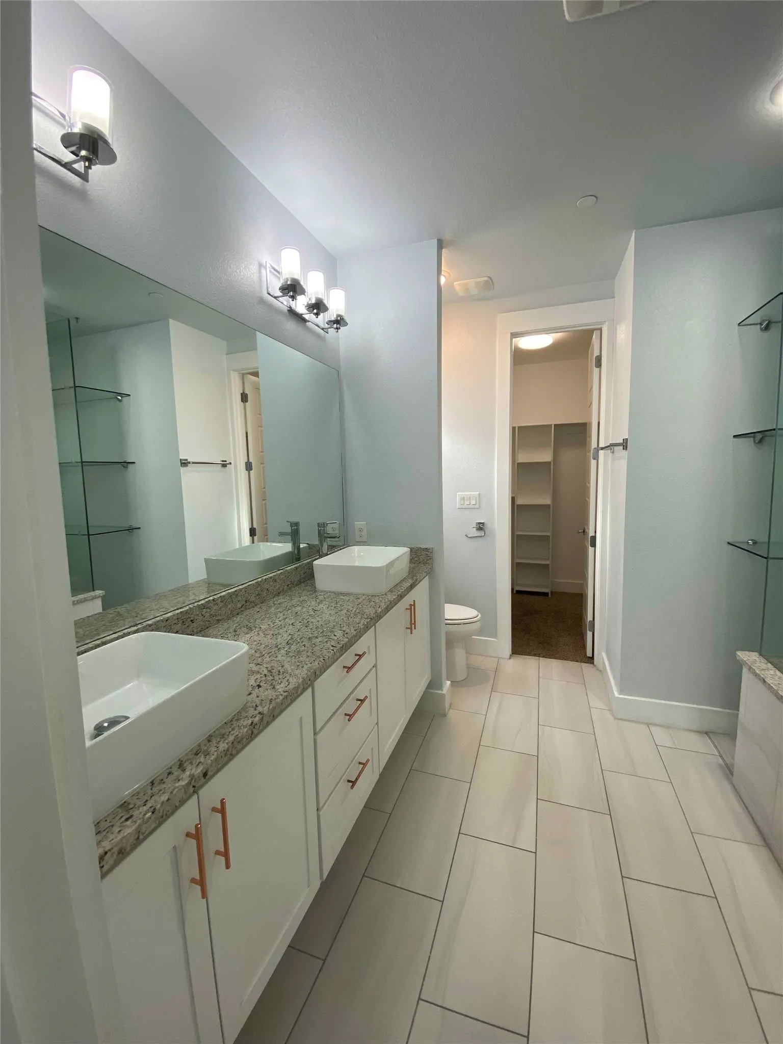 Full bath with a spacious closet and double vanity