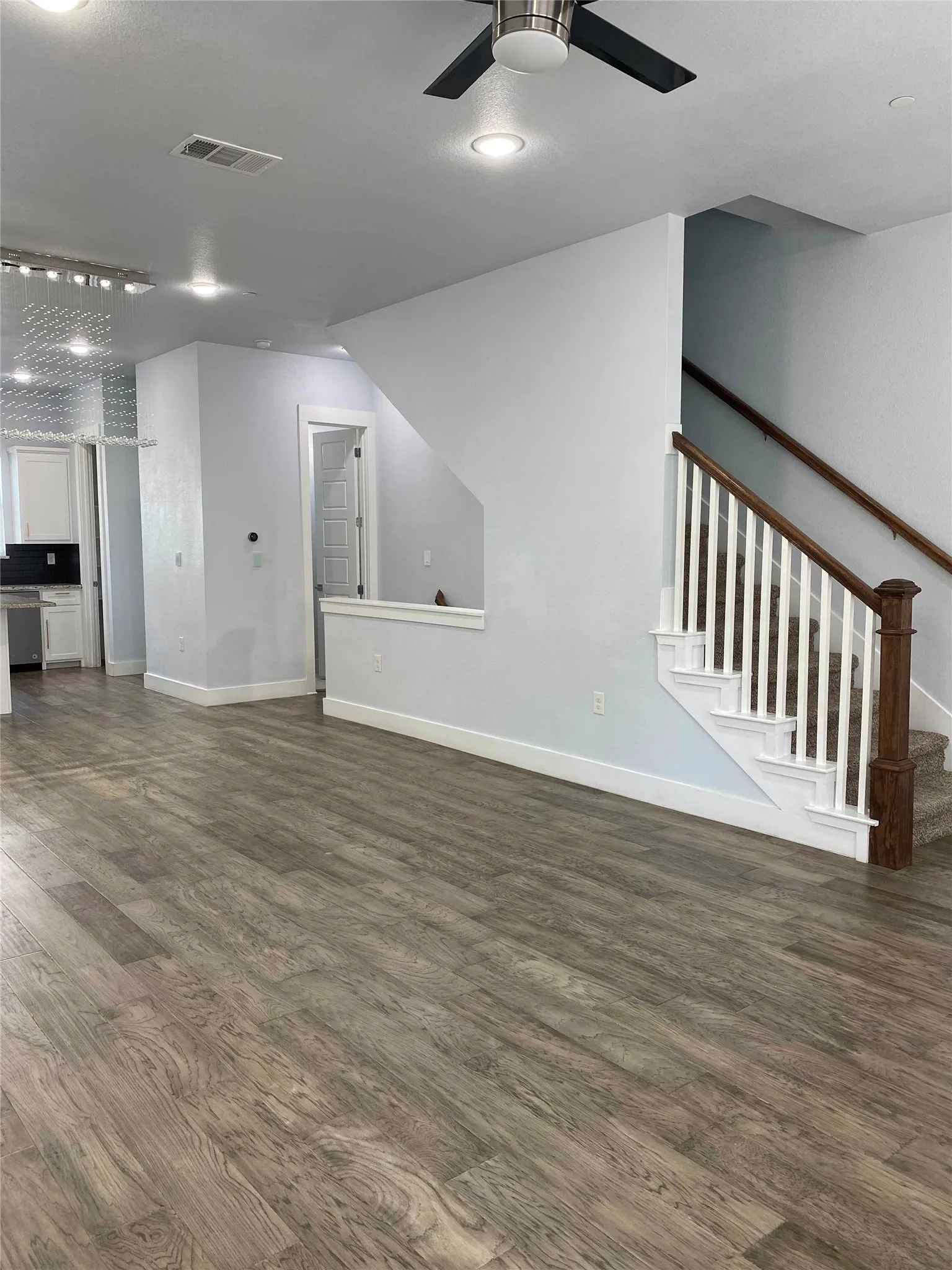 Unfurnished living room featuring ceiling fan, dark wood finished floors, and recessed lighting