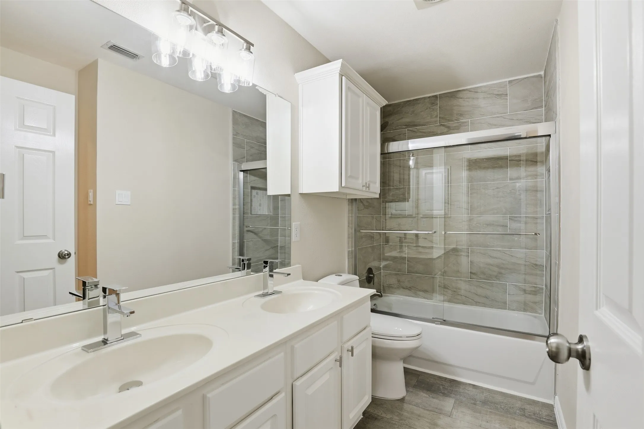Full ensuite bathroom upstairs with dual sinks