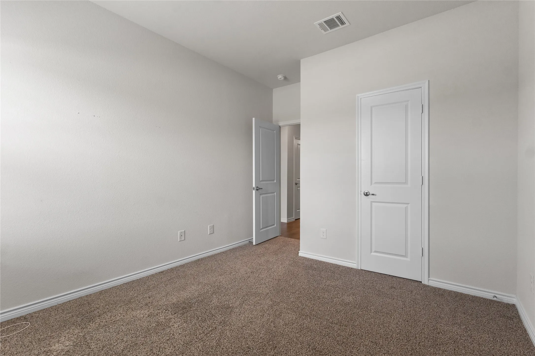 Unfurnished bedroom featuring carpet flooring and baseboards
