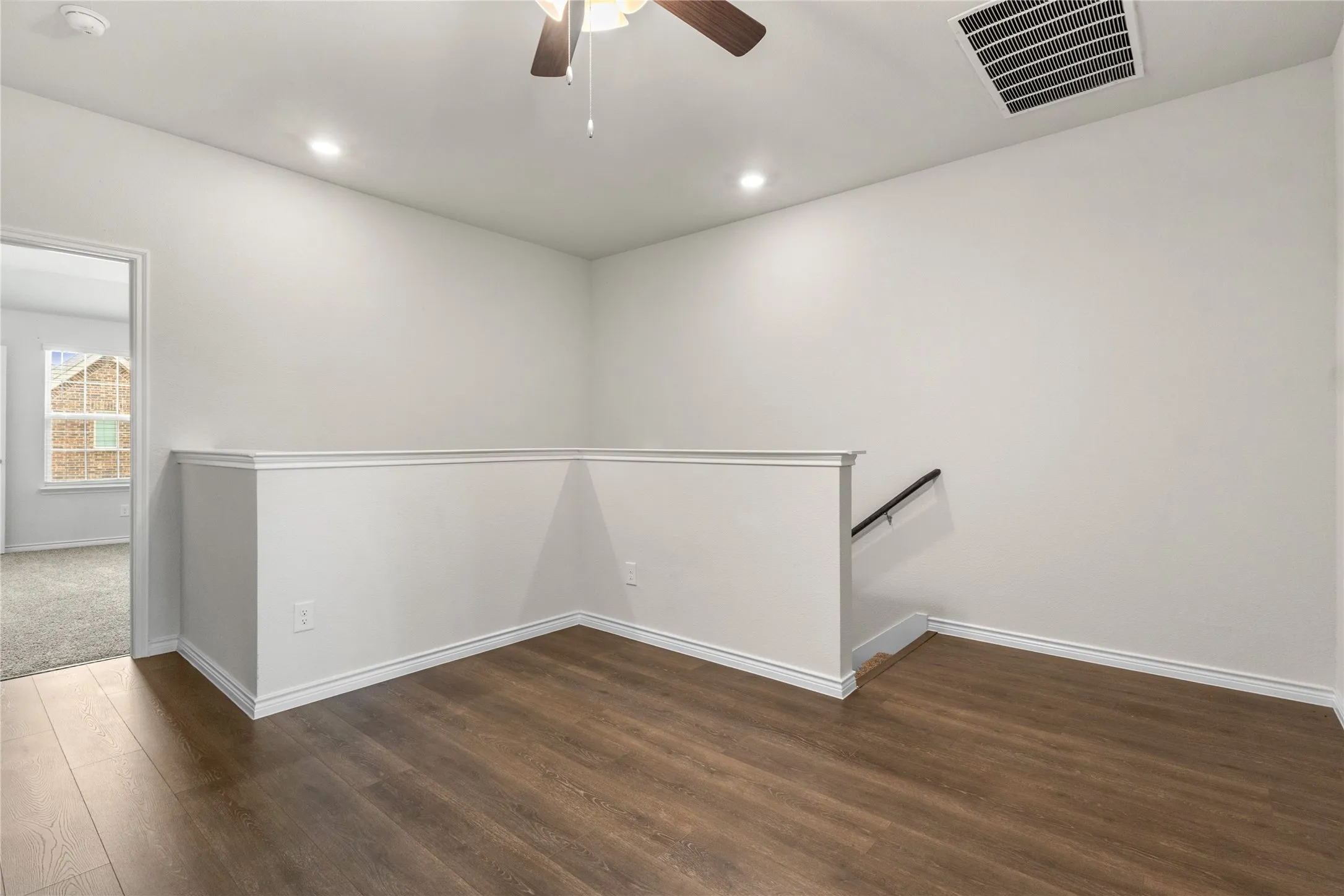 Spare room featuring a ceiling fan, wood finished floors, baseboards, recessed lighting, and a smoke detector