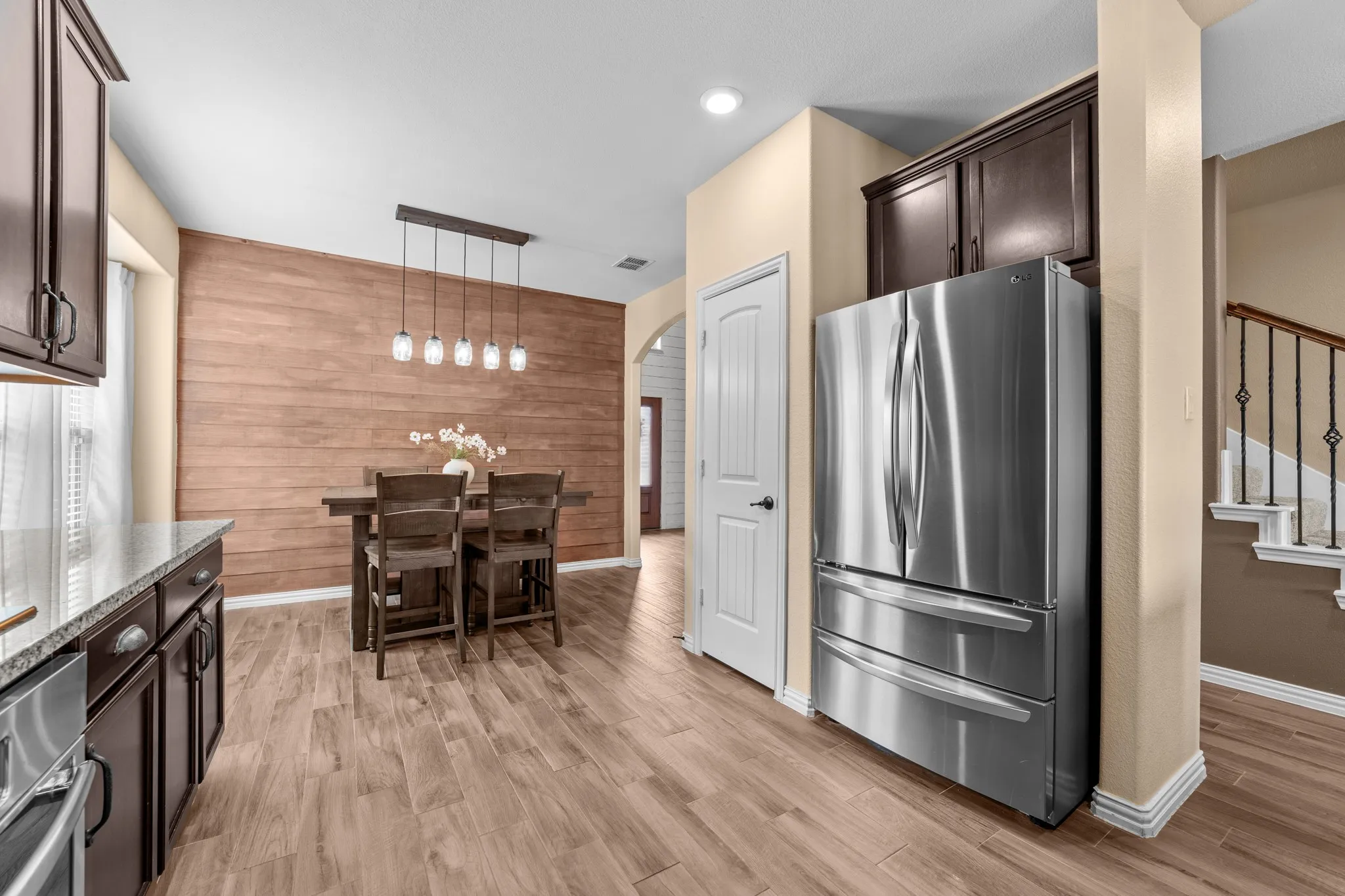 Wood-finish flooring throughout, complemented by a wood plank accent wall