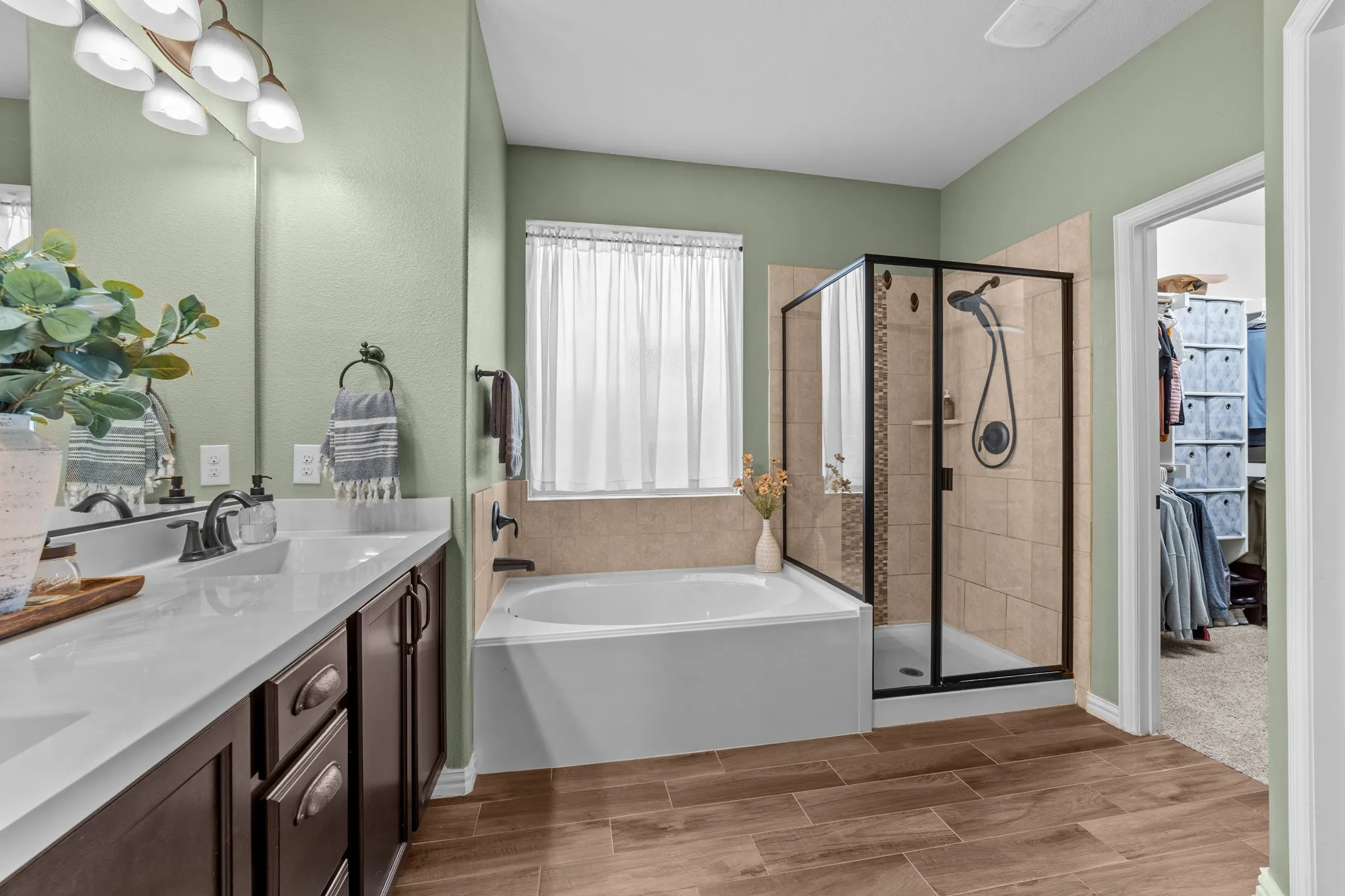 Dual vanity with white countertops, undermount sinks, and dark wood-finish cabinetry