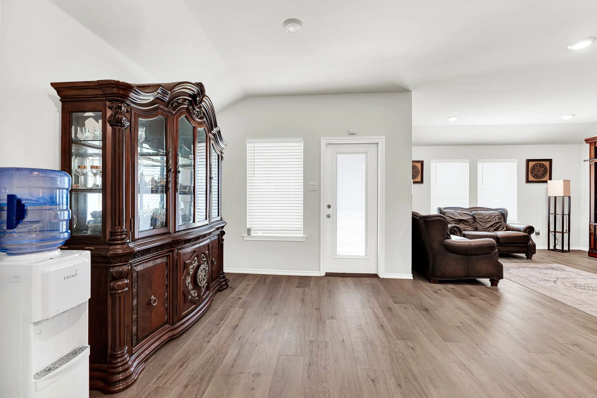 Positioned right off the kitchen, this bright dining space offers durable wood-look flooring, direct patio access through a glass door, and a bright picture window. It provides a welcoming spot for sitting down to weekend brunches or hosting lively dinner parties.