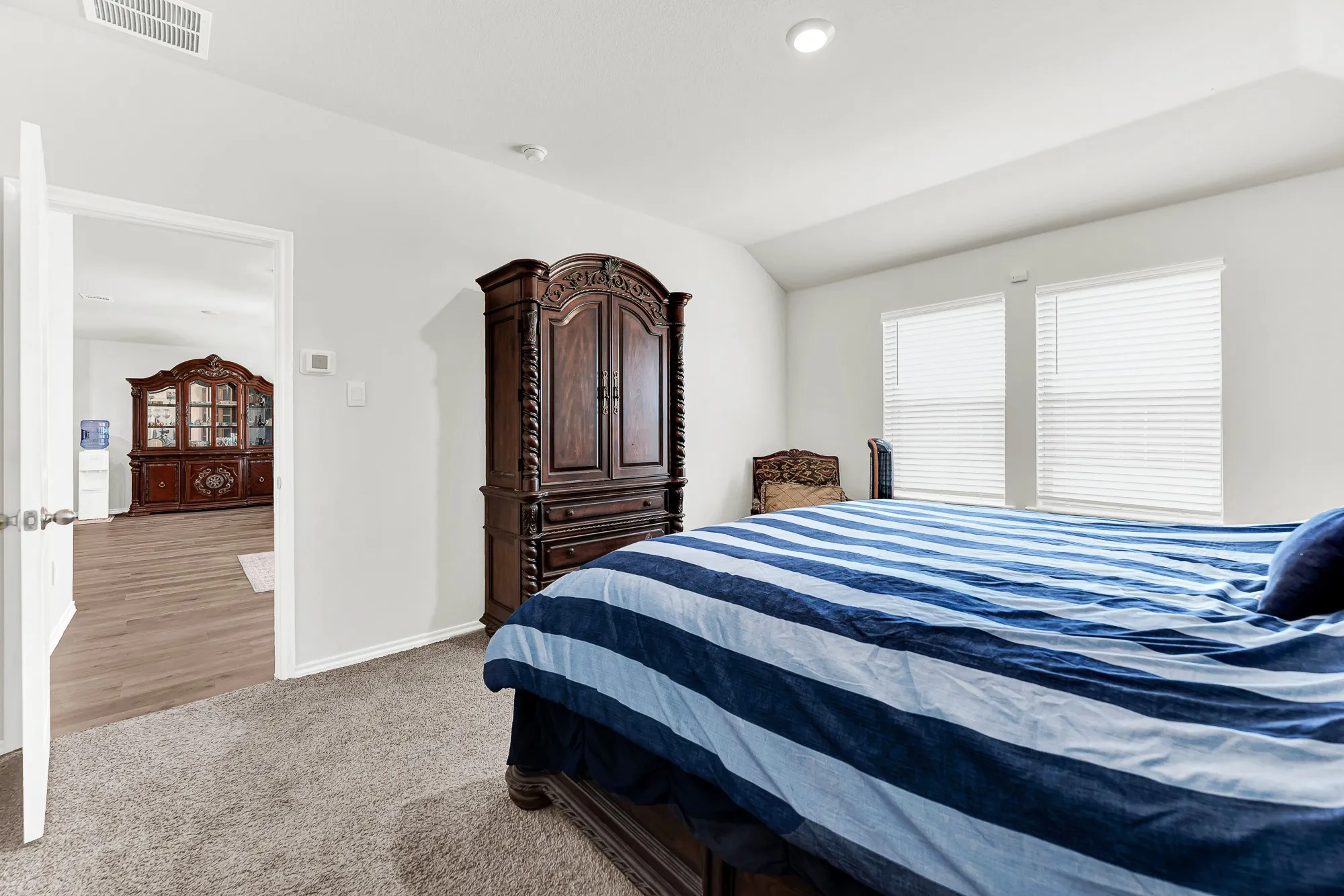 This comfortable sleeping space features clean sightlines into the main living areas through a wide doorways, creating a secluded feel. You will love having your own private quiet zone situated just steps from the heart of the home.