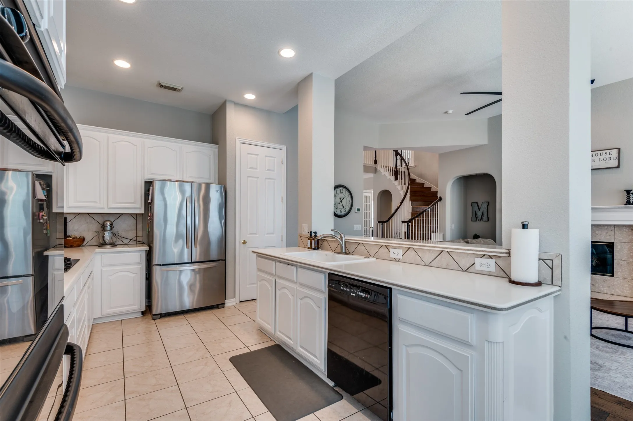 Kitchen looking towards living and beautiful staircase