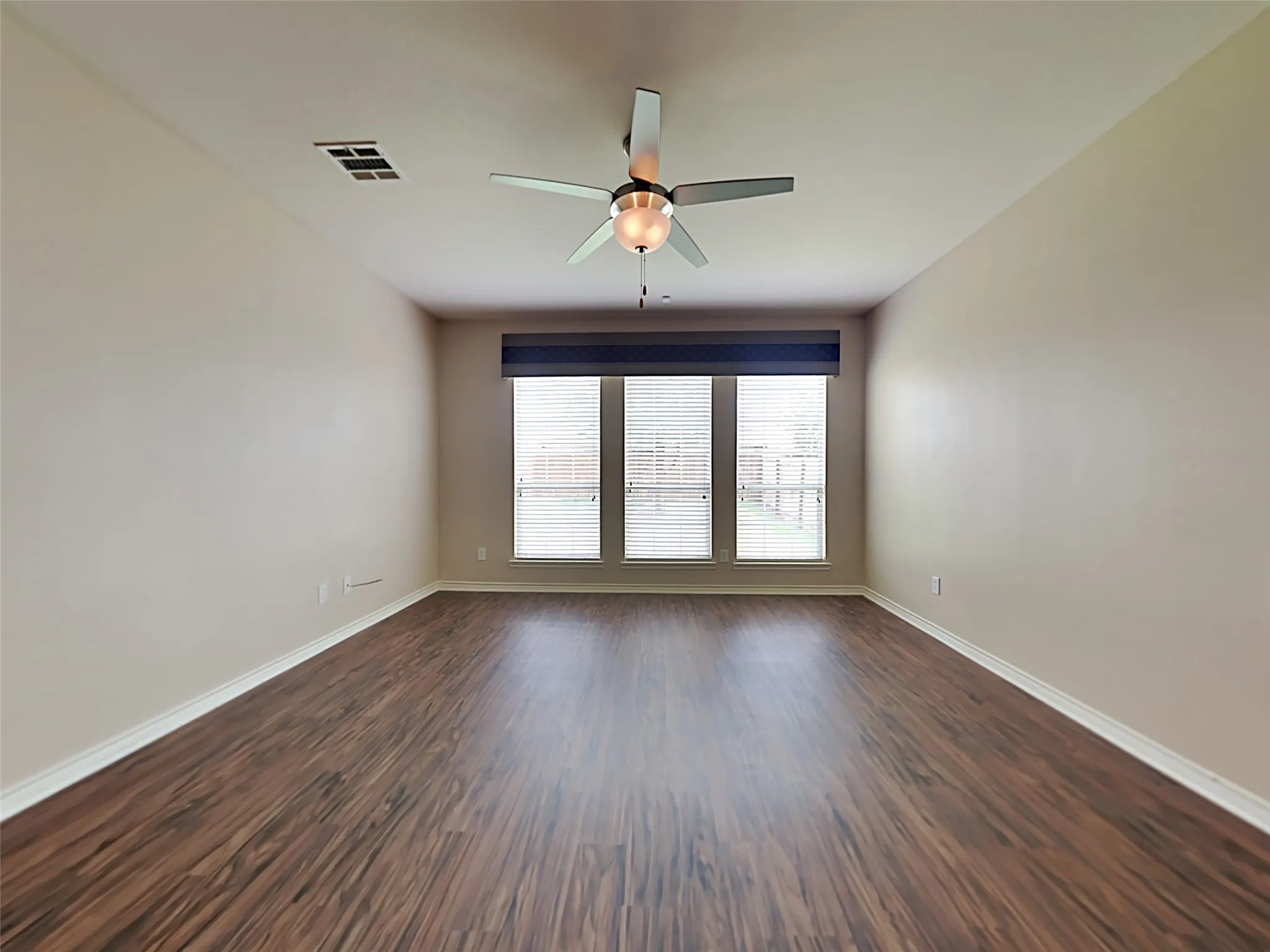 Recessed lighting, wood-finish flooring, white baseboards, triple windows, and a ceiling fan with light fixture