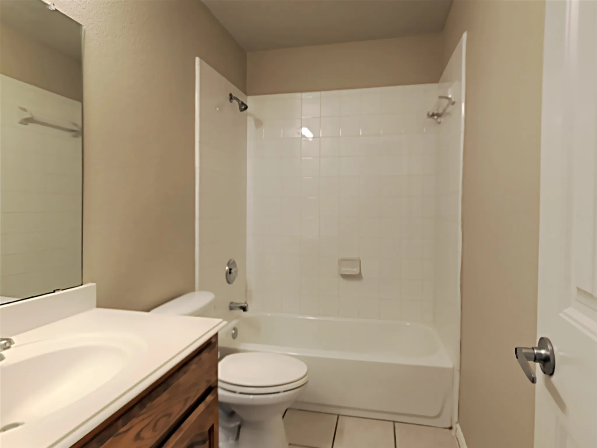 White porcelain tub and shower combination with chrome fixtures