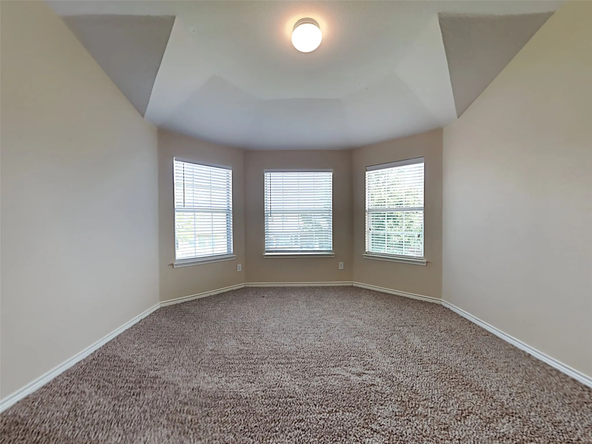 Tray ceiling with a central flush-mount light fixture