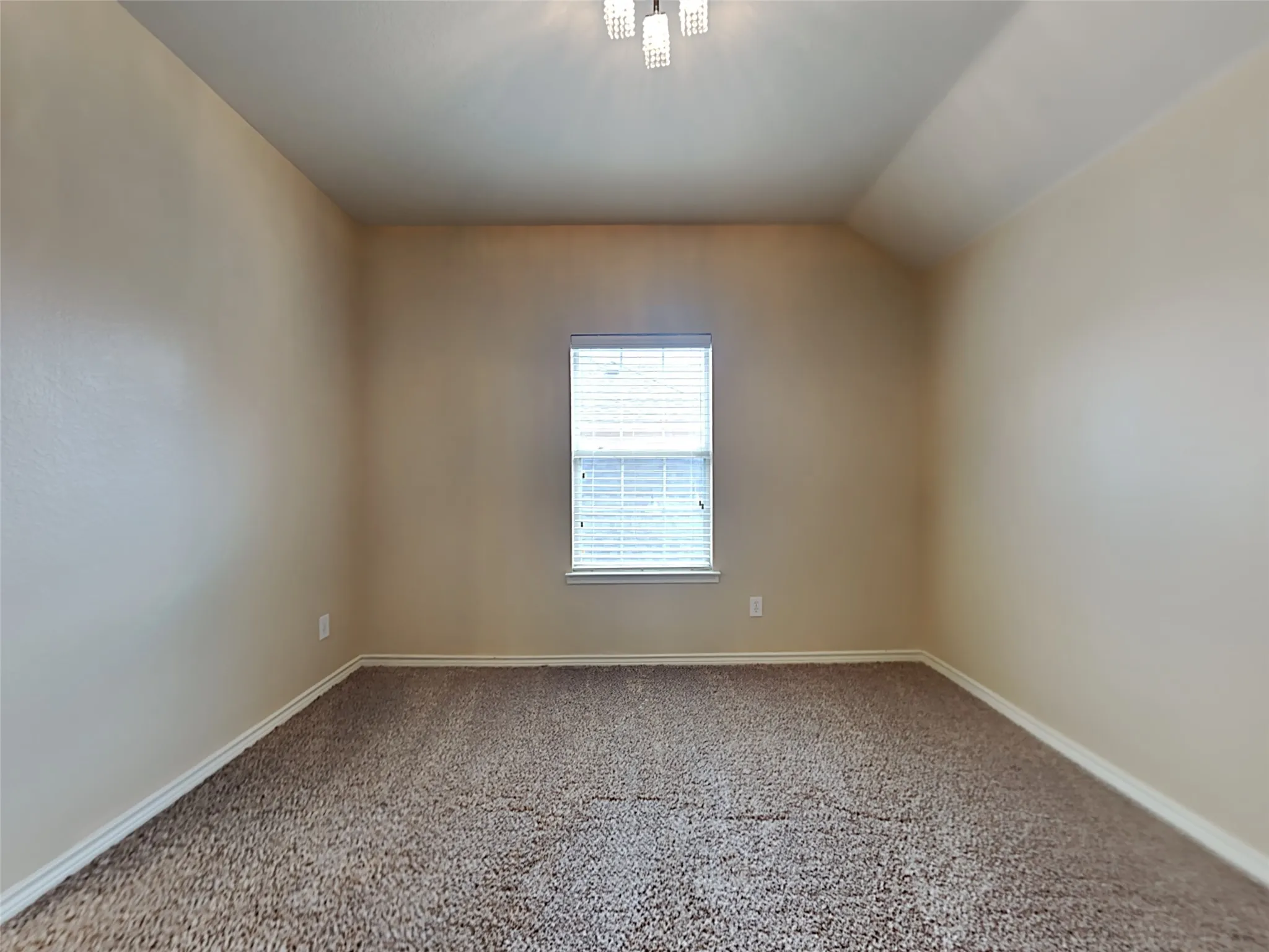 Carpeted flooring, neutral wall tones, window with horizontal blinds, and a flush-mount ceiling light