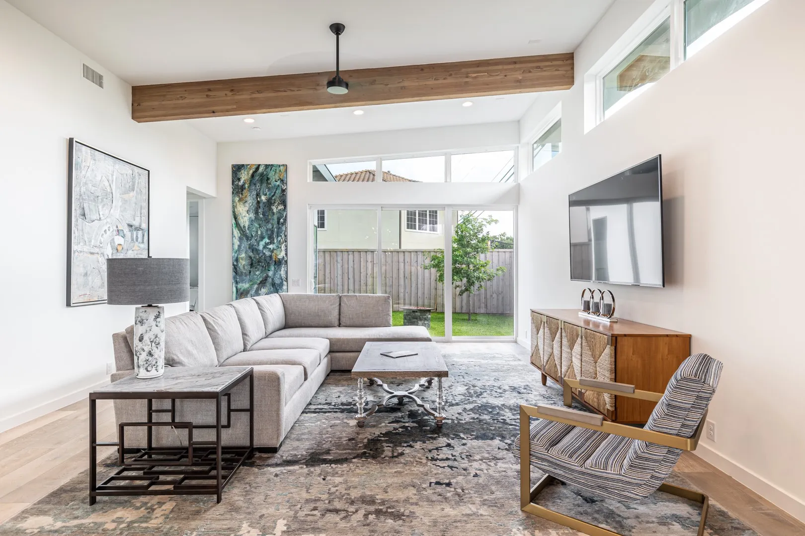 Living room with wood finished floors, beamed ceiling, and recessed lighting