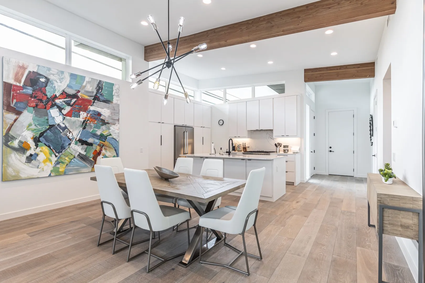 Dining area with recessed lighting, beam ceiling, and light wood-type flooring