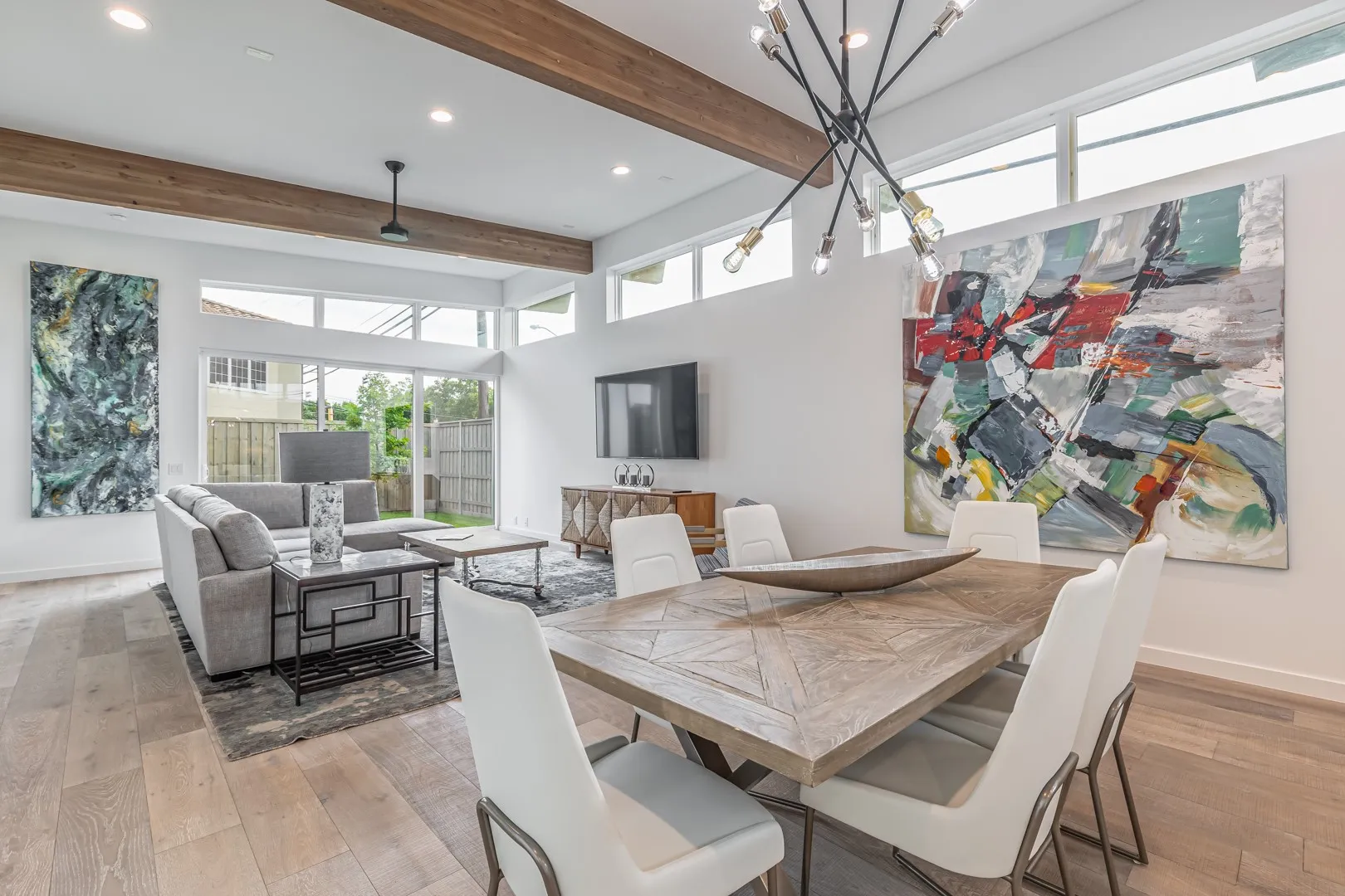 Dining space featuring beamed ceiling, light wood-style flooring, recessed lighting, and a chandelier