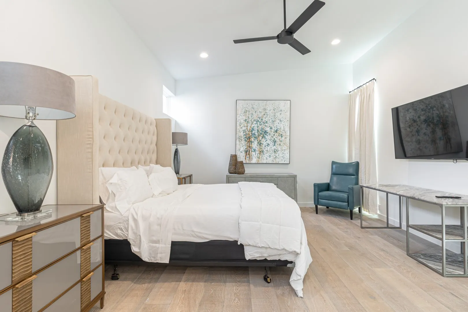 Bedroom with wood finished floors, recessed lighting, radiator heating unit, and ceiling fan