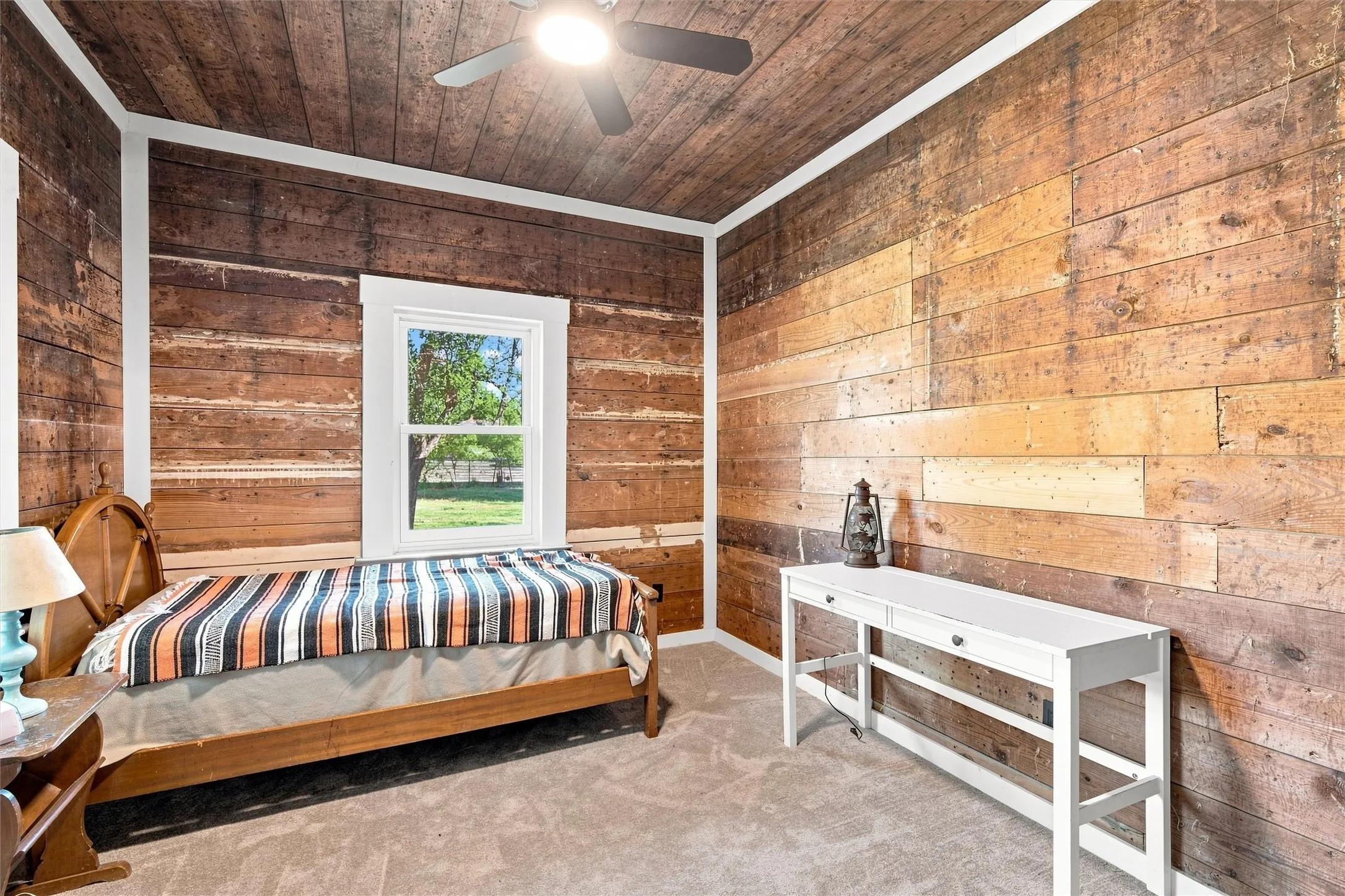 Wood plank ceiling with a ceiling fan