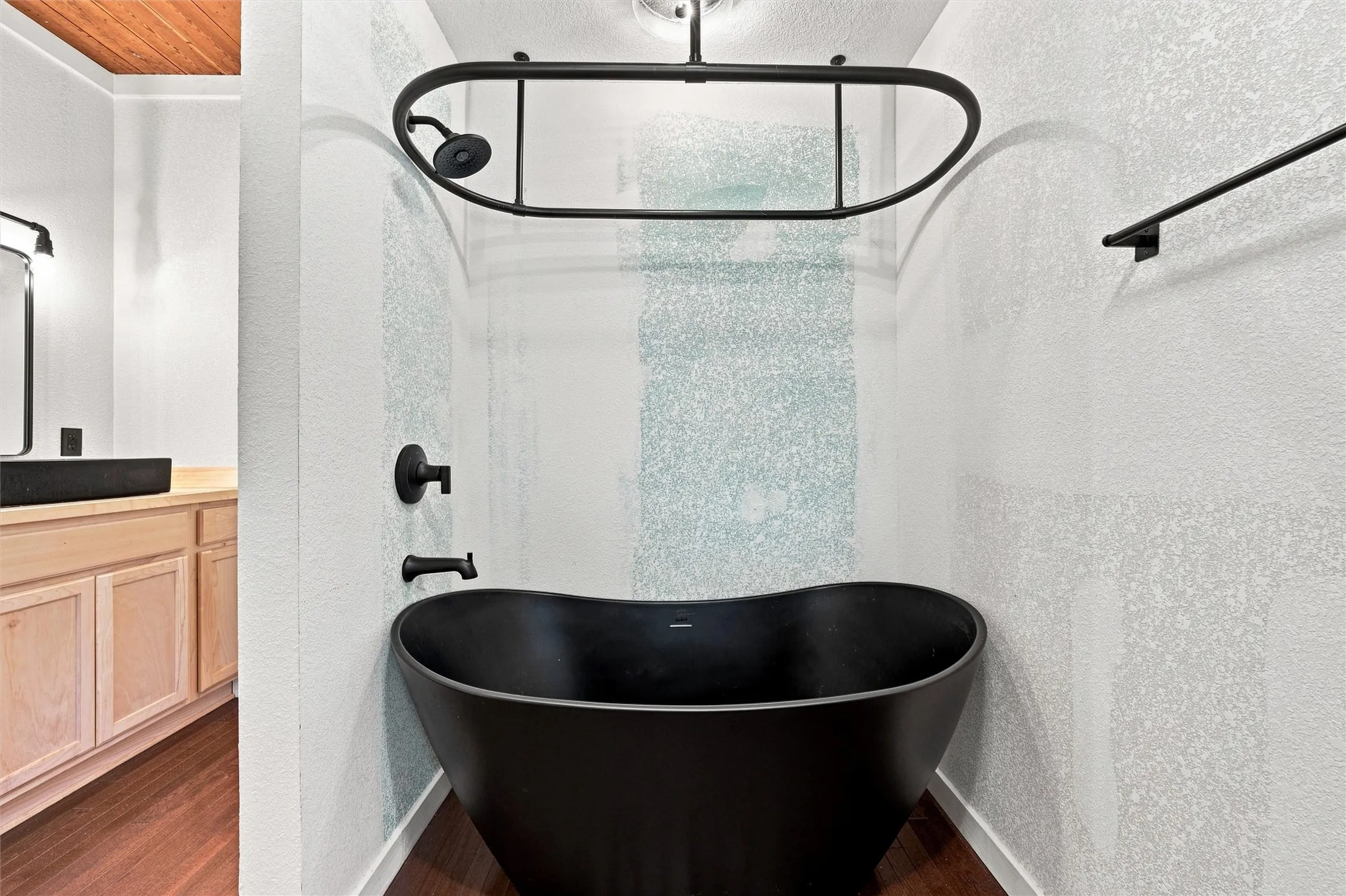 Matte black freestanding soaking tub with matte black fixtures