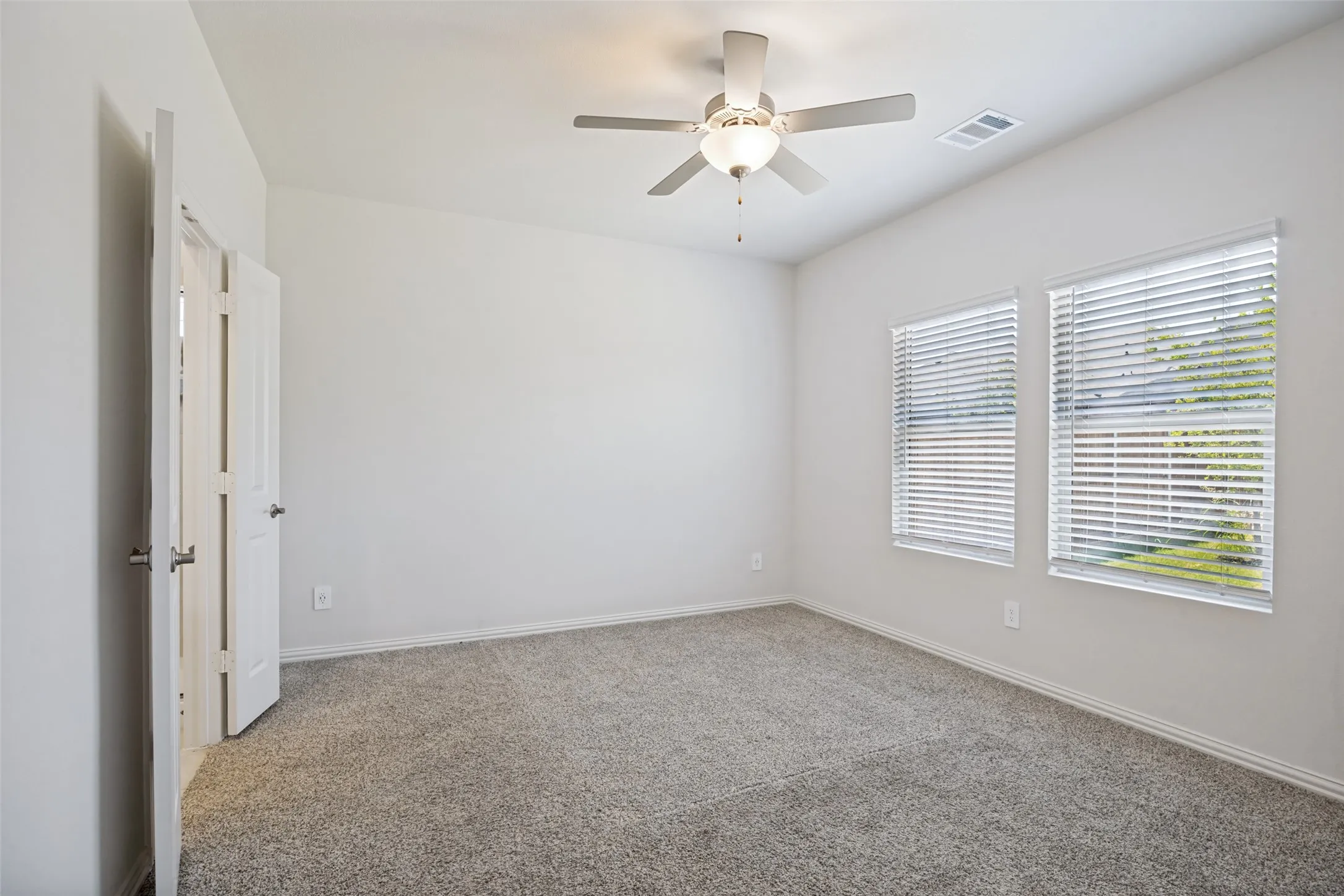 Spacious primary bedroom with its private en-suite and very large walk-in closet and beautiful view of your backyard