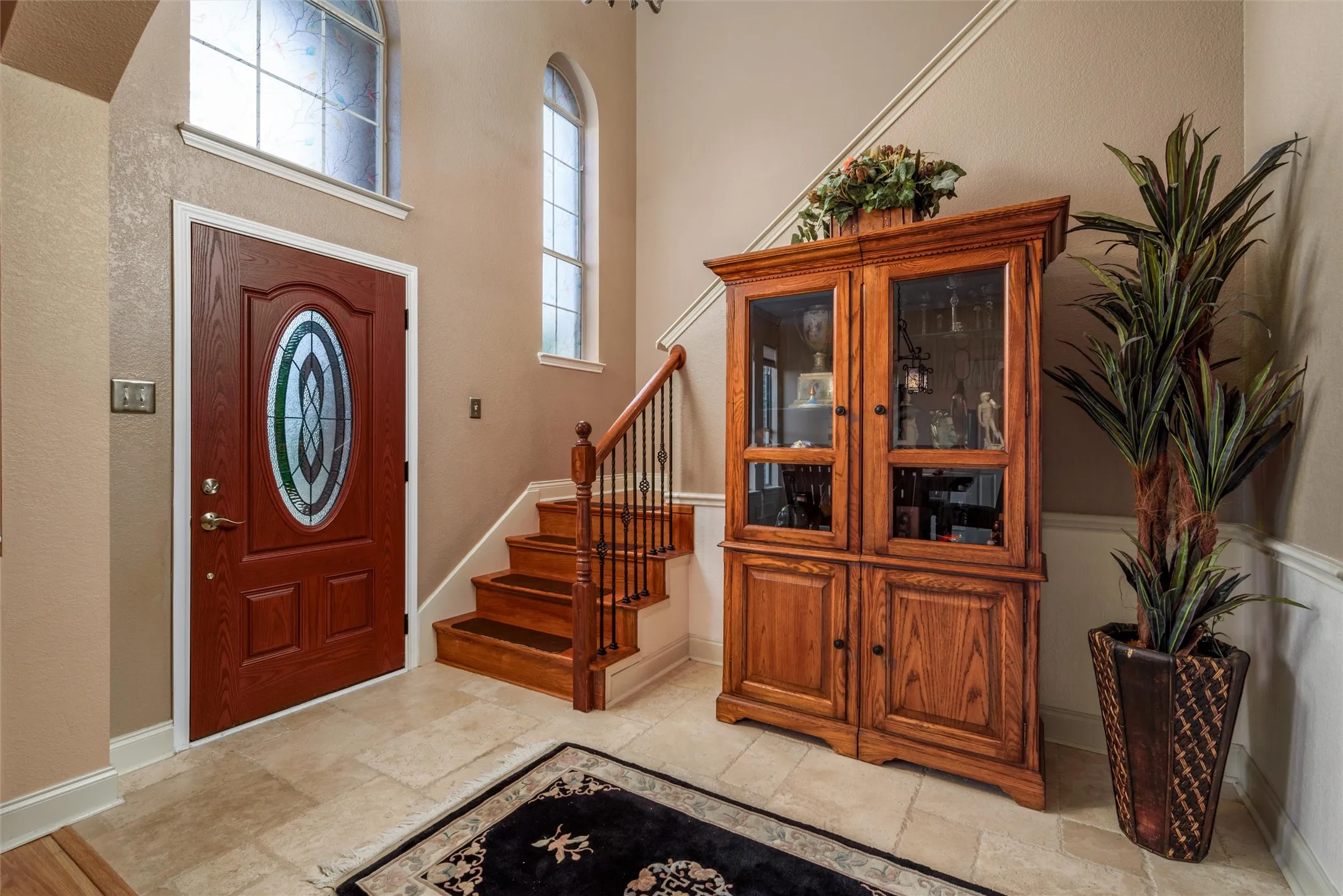 Enter into a foyer with high ceilings and natural light.