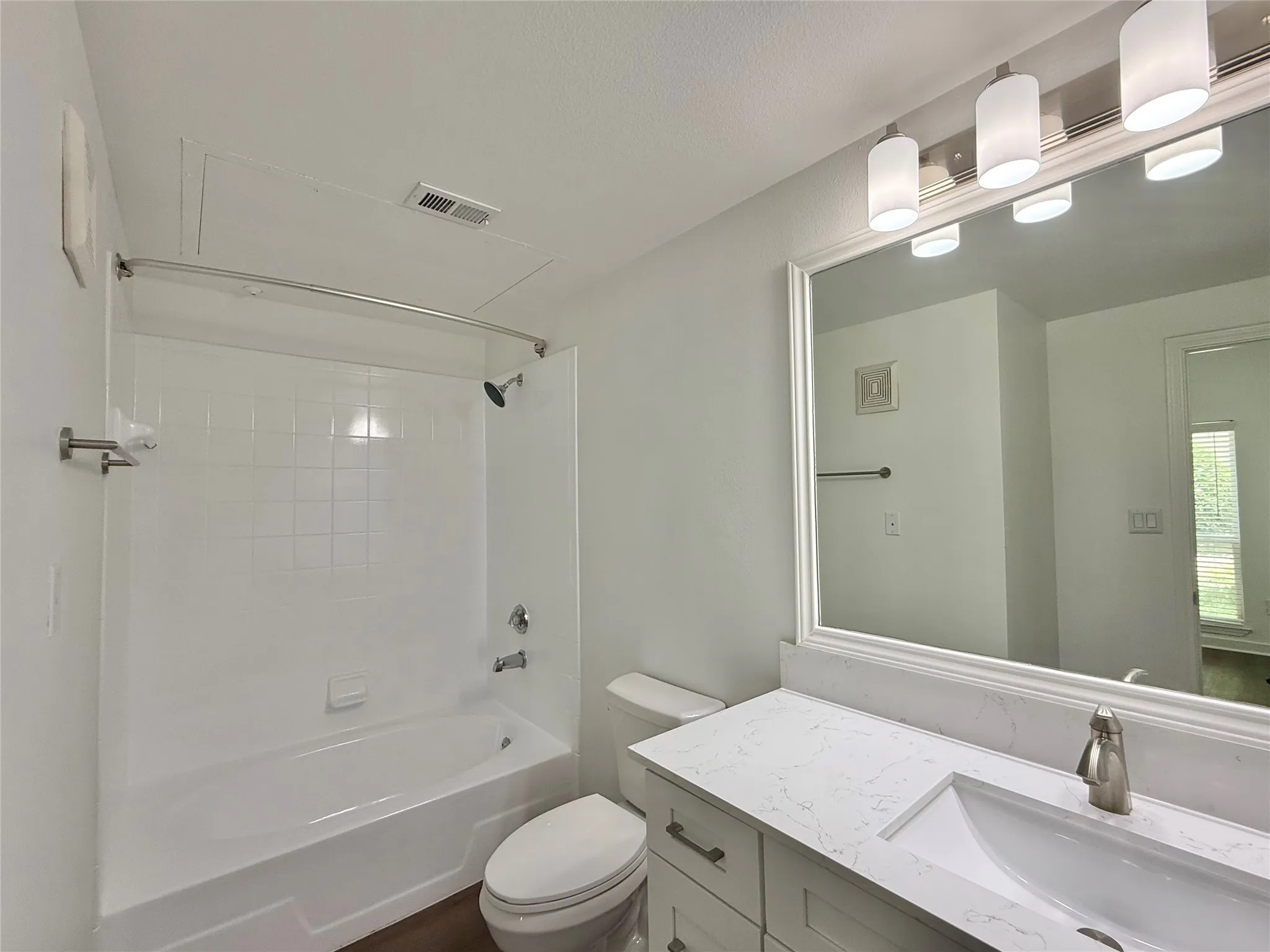 Full bath with washtub / shower combination, vanity, and toilet
