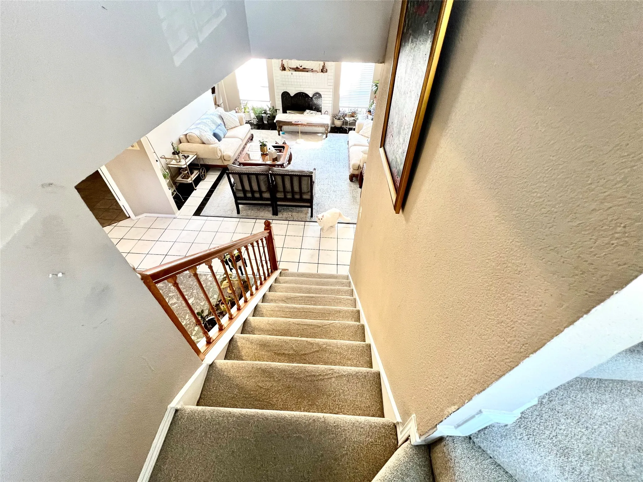 Stairs featuring a textured wall and vaulted ceiling