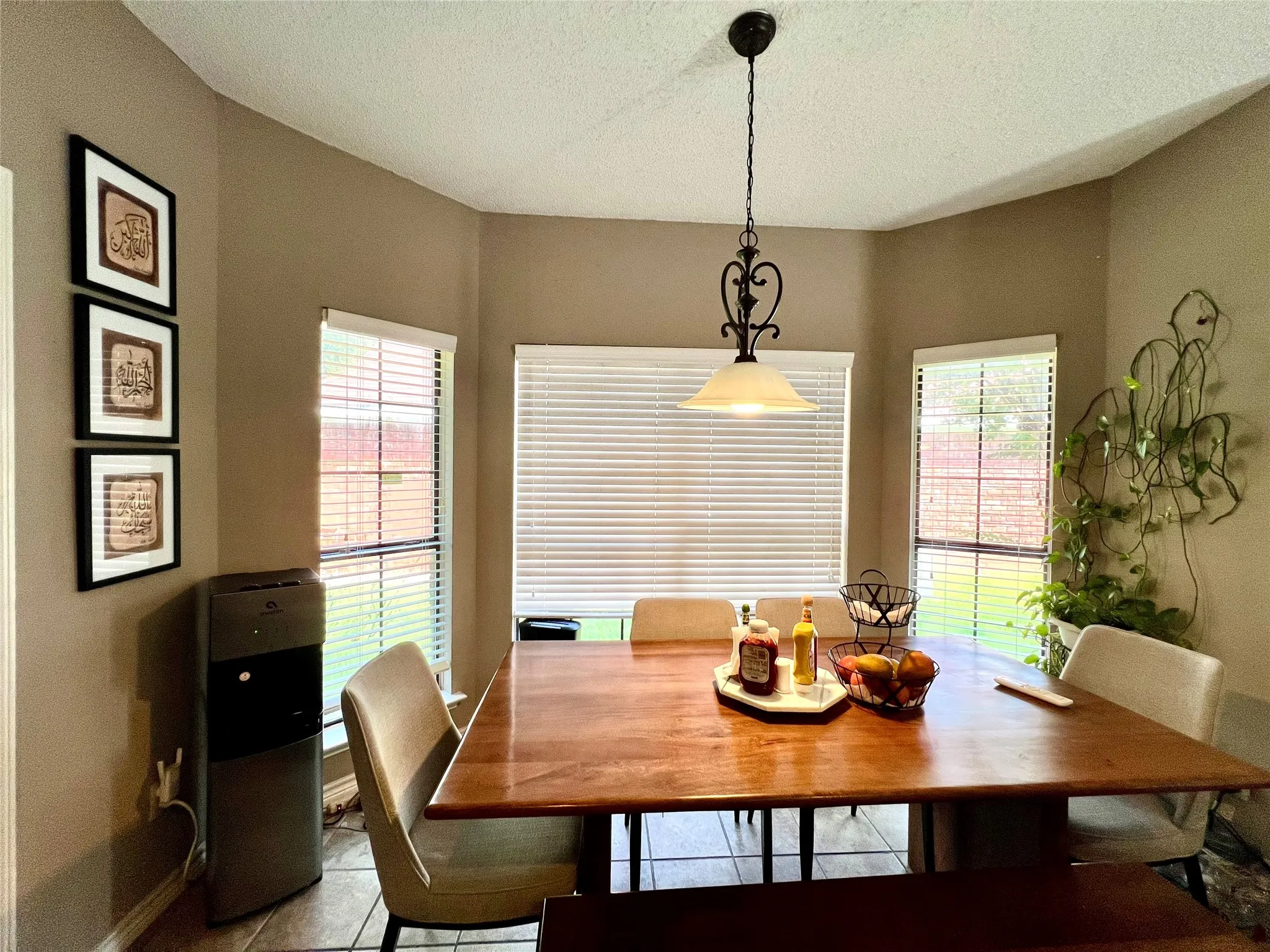 Dining space with tile patterned floors and a textured ceiling