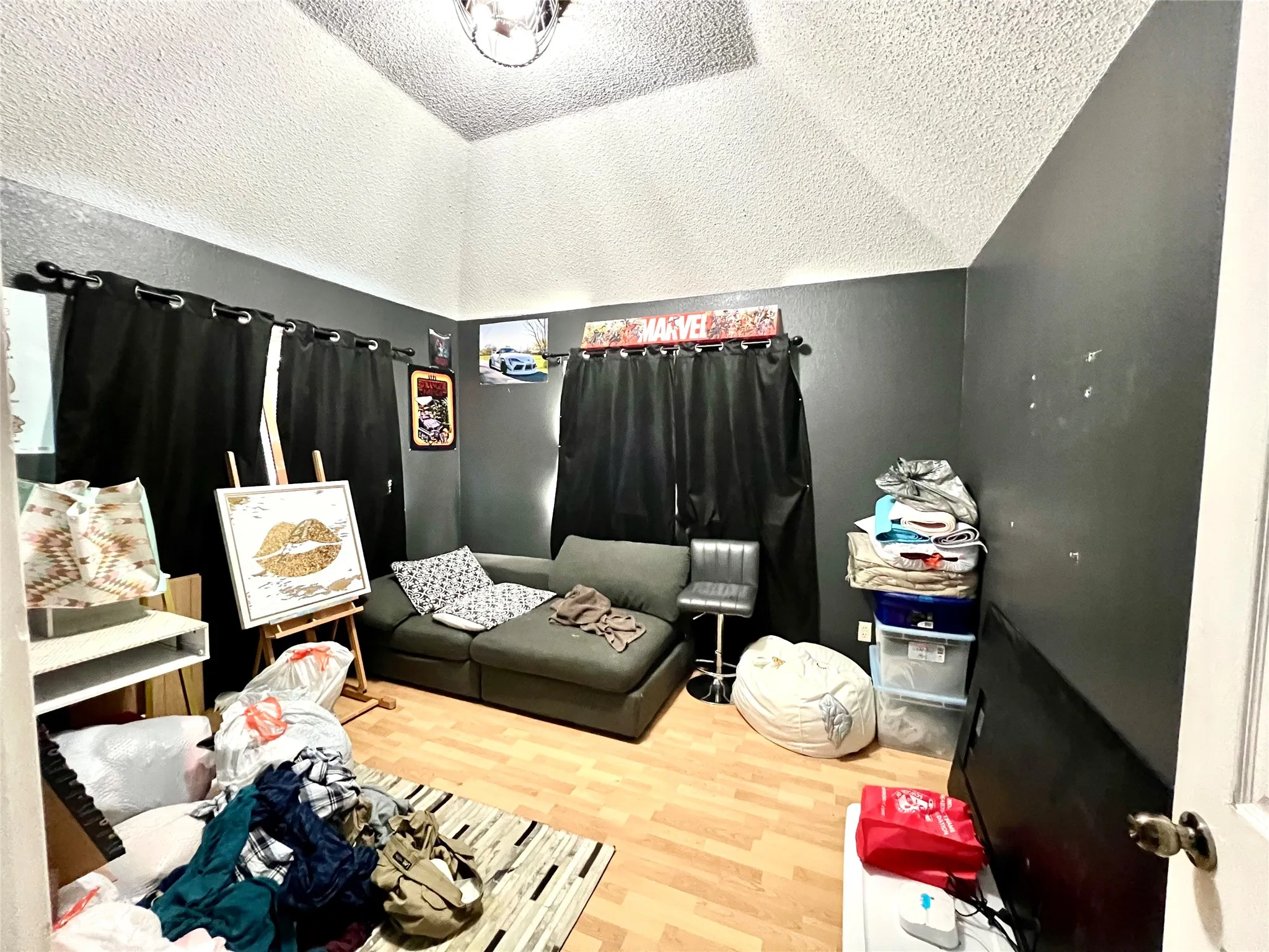 Bedroom featuring wood finished floors and a textured ceiling