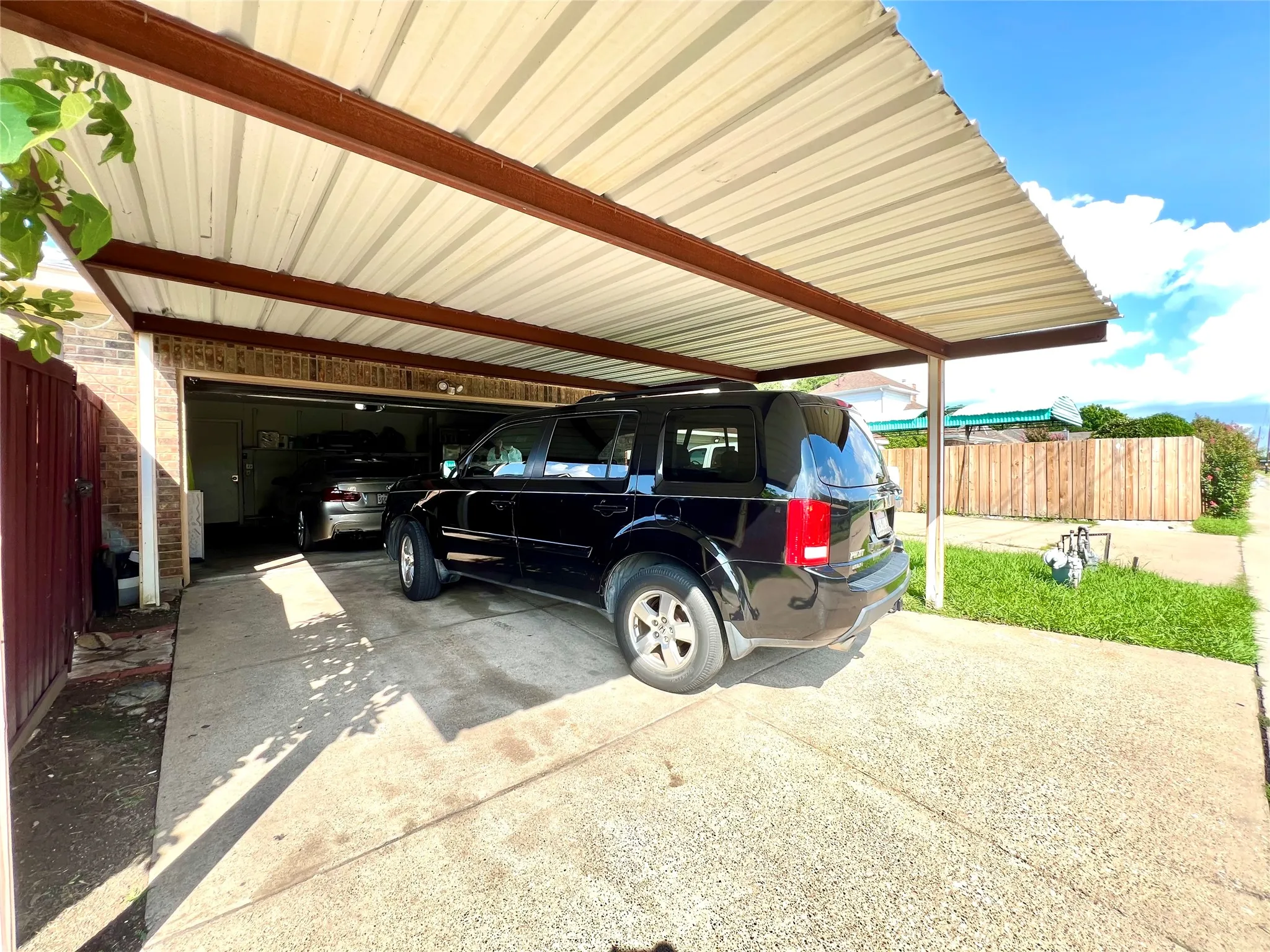 View of parking / parking lot with driveway, a garage, and a carport
