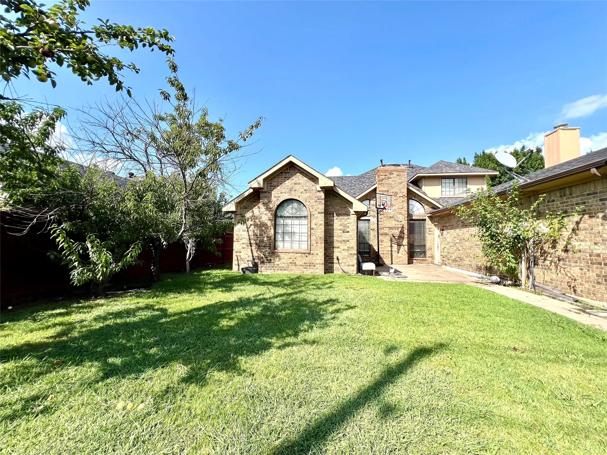 View of front of property featuring brick siding and a front lawn